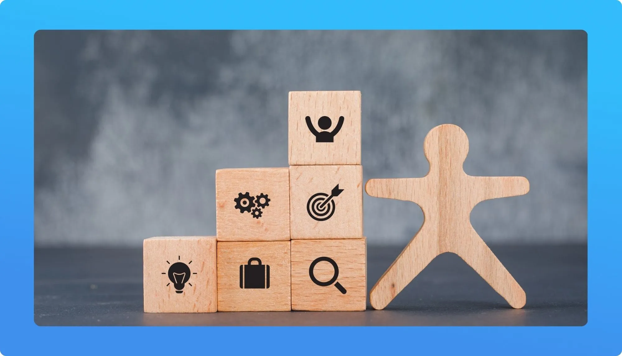 A wooden figure stands beside stacked blocks featuring icons for creativity, teamwork, goals, career, and research, symbolizing growth.