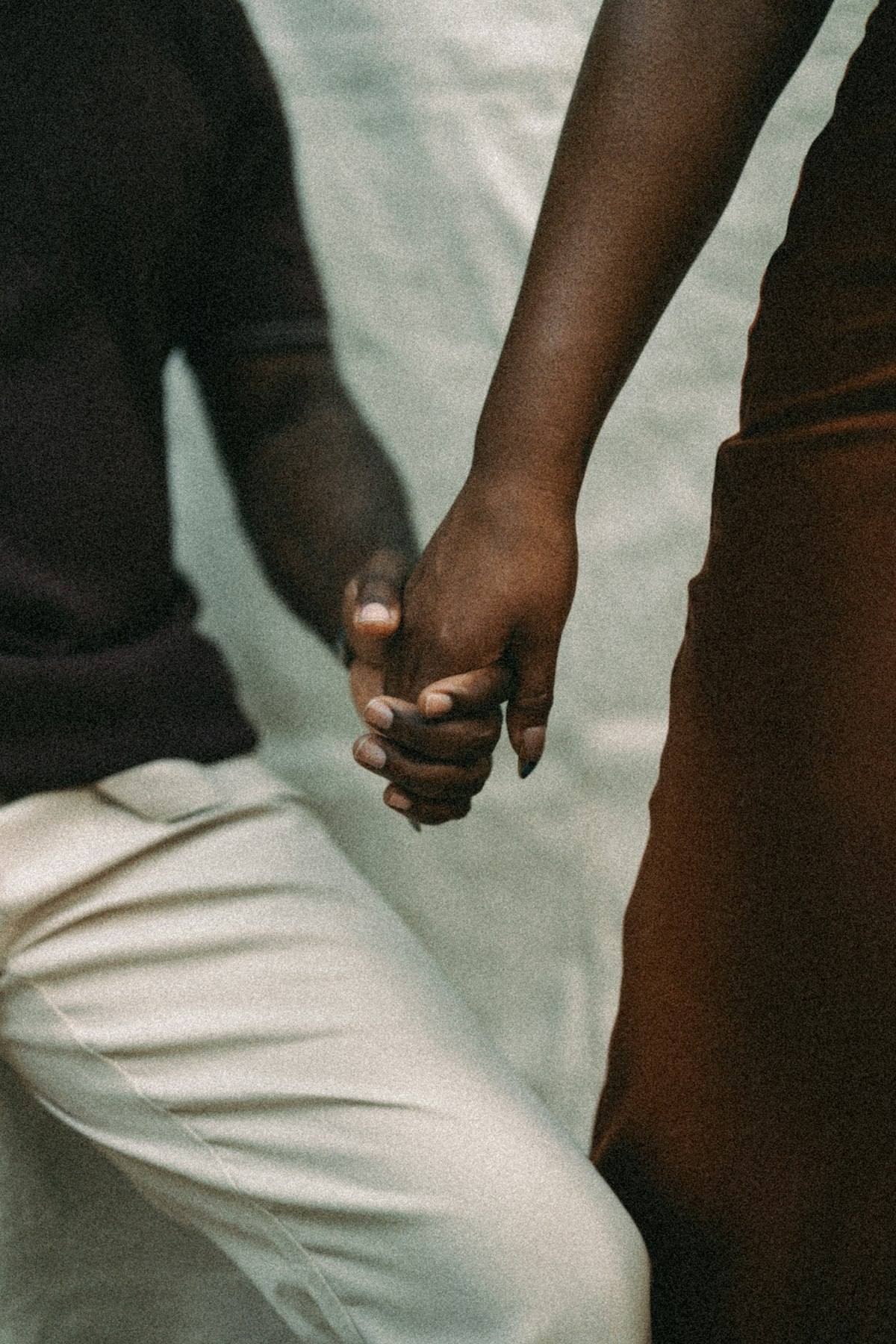 A man and a woman hold hands.