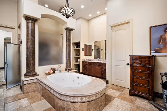 A bathroom with a large tub and a sinkAI-generated content may be incorrect.