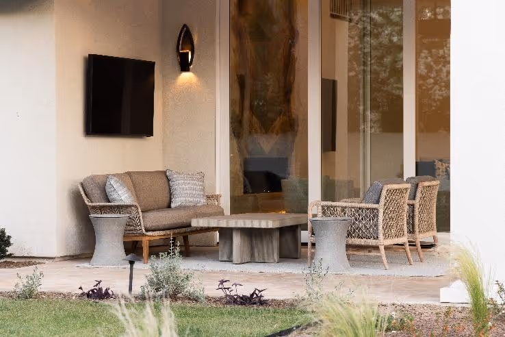 A patio area with a television on the wallAI-generated content may be incorrect.