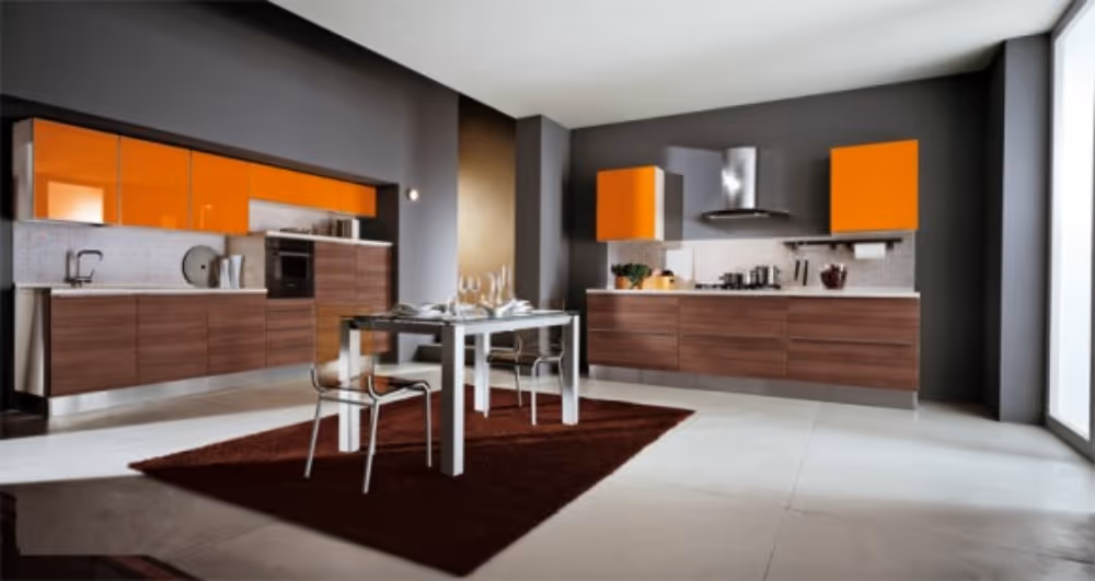 The orange accents stand out against the grey walls as bold design statements in this kitchen