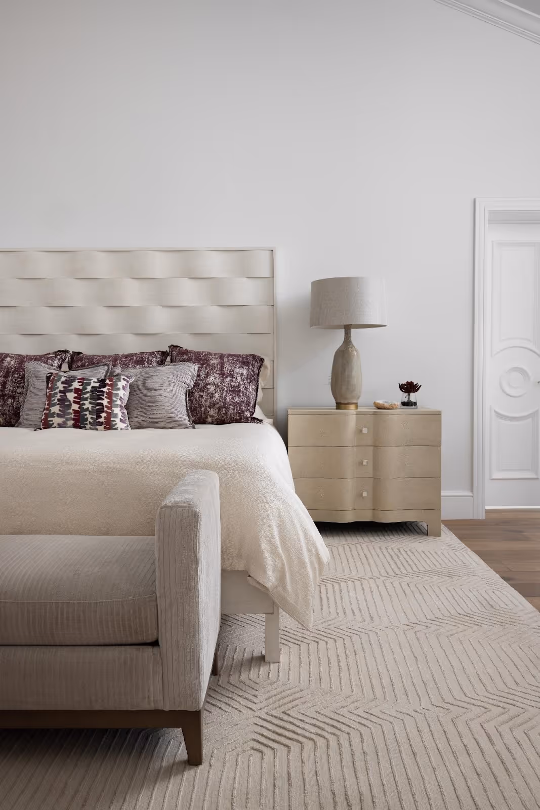 A bed with pillows and a lamp in a roomAI-generated content may be incorrect.