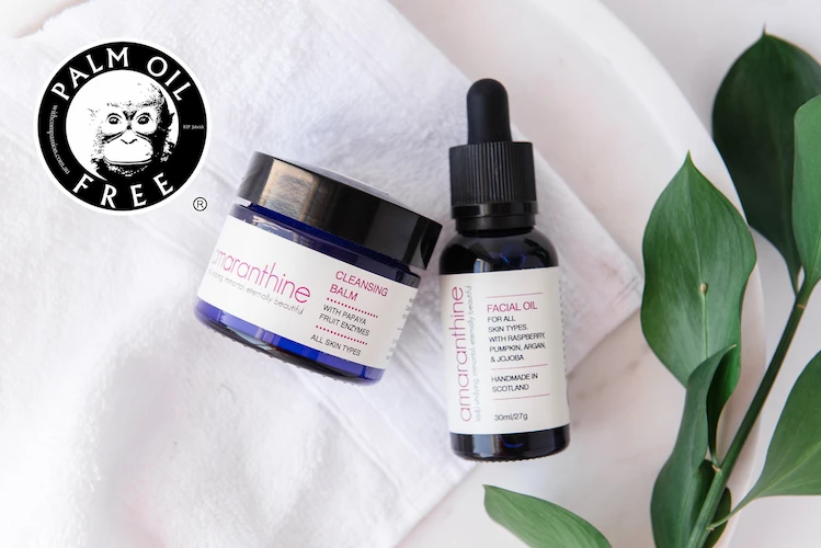 Two Amaranthine skincare products — a cleansing balm and facial oil — displayed with the Palm Oil Free Certification Trademark logo, symbolising ethical and sustainable beauty.