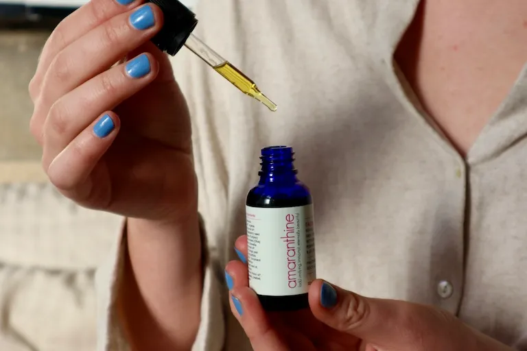 Applying a few drops of facial oil as part of a gentle, aromatherapy-inspired skincare ritual.