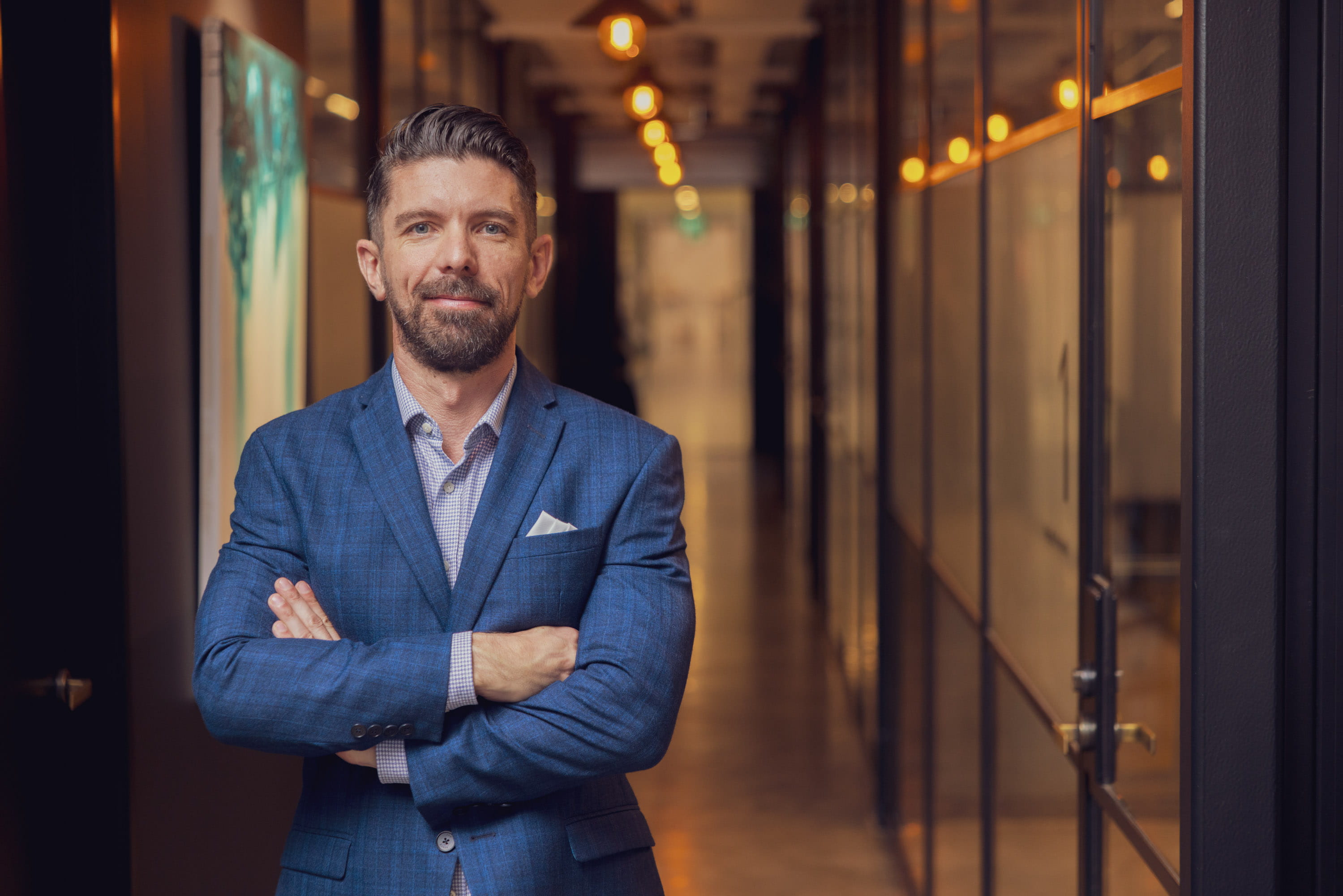 Joseph, CEO, standing with arms folded