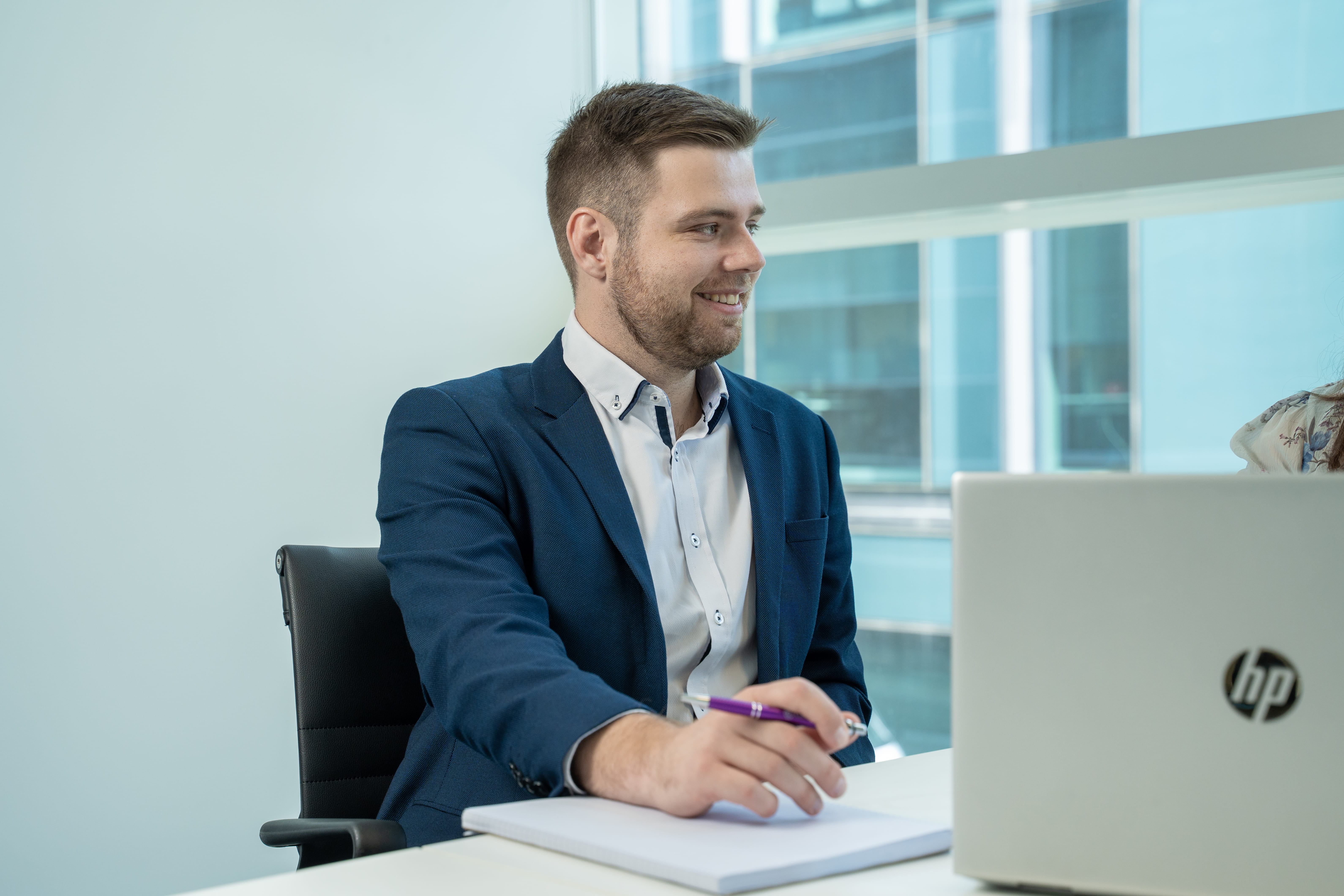 Josh Copeland, Become Wealth financial adviser, sitting with a client (obscured, partly off-screen)