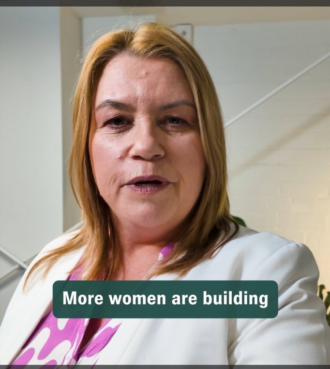 Vinessa, standing and facing camera, discusses women and wealth in NZ