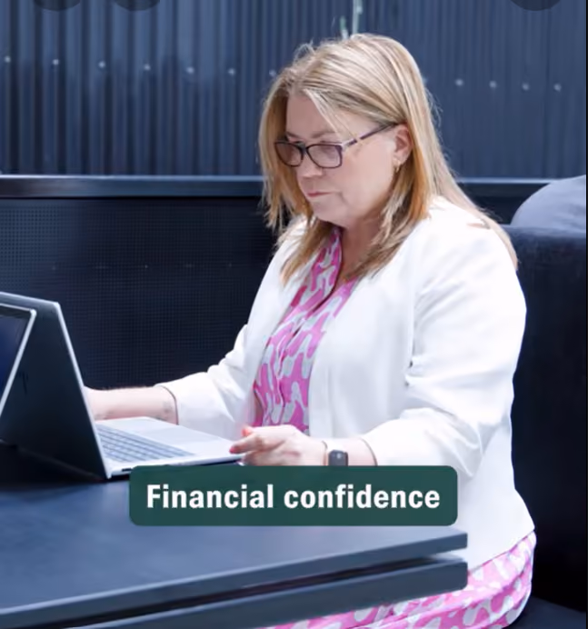 Vinessa Orsbourn, seated at a laptop, discusses women and wealth in NZ