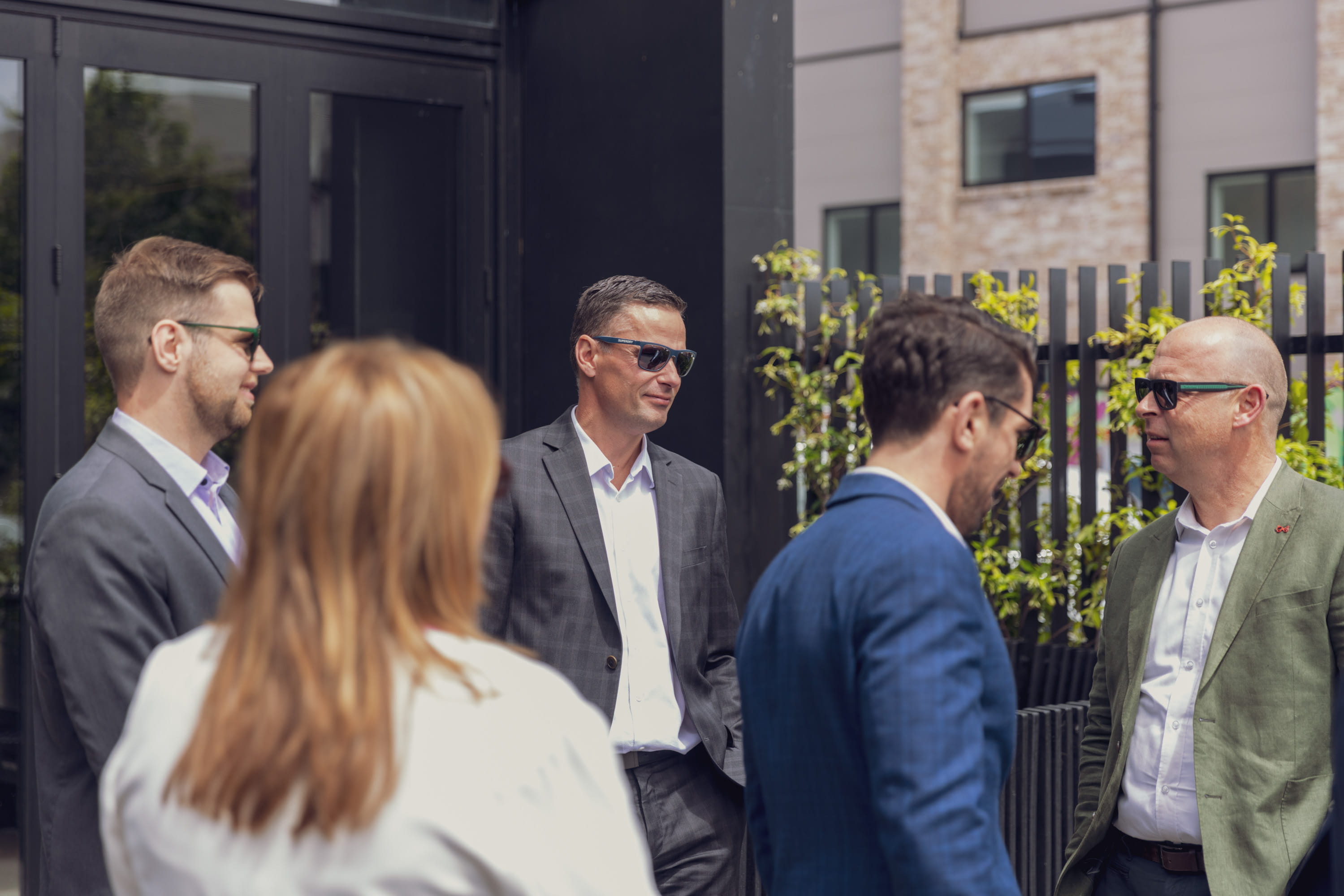Financial advisers of Become Wealth, standing in sun, discussing more income