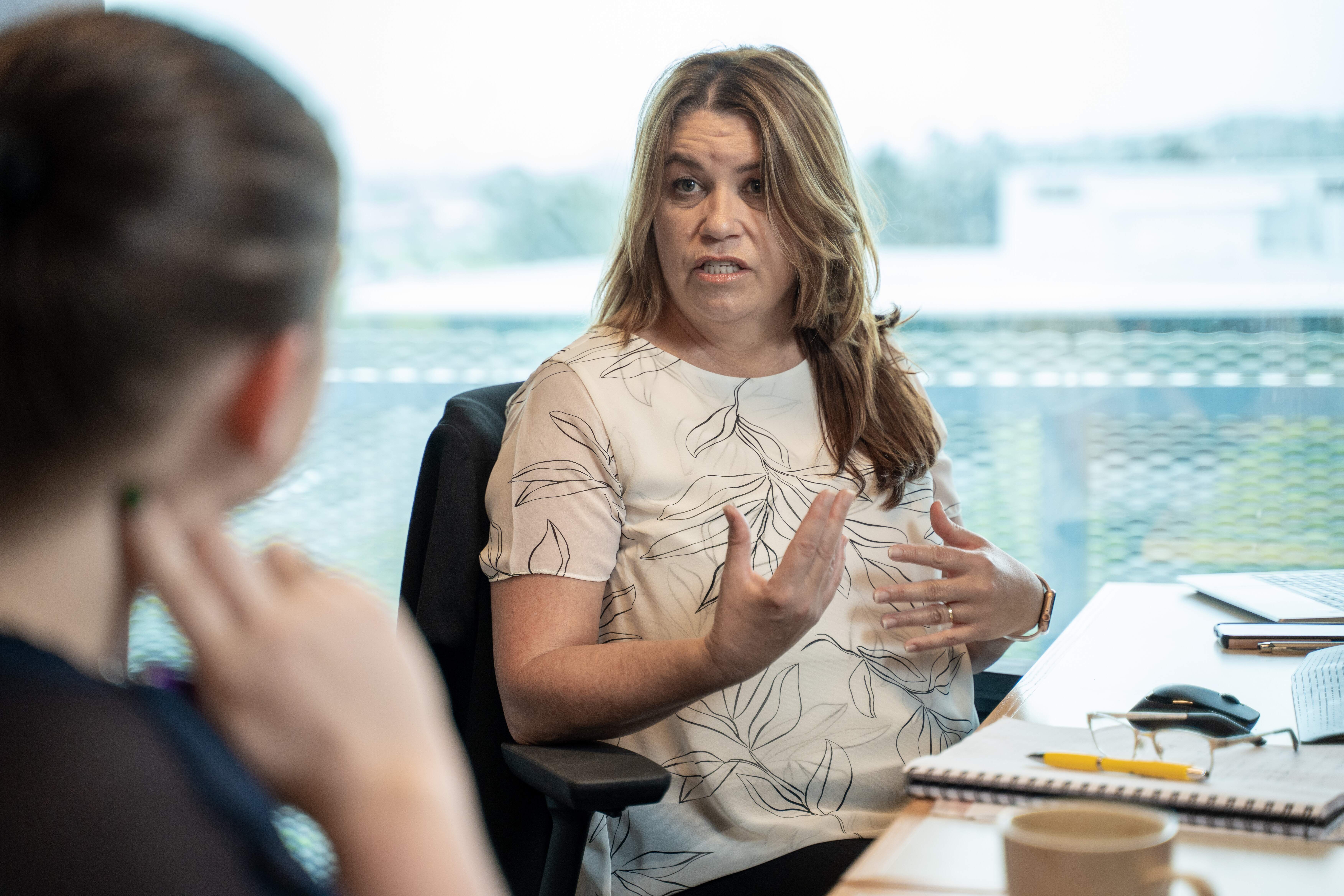 Vinessa, financial adviser at Become Wealth talking with a client in Become Wealth's Auckland office
