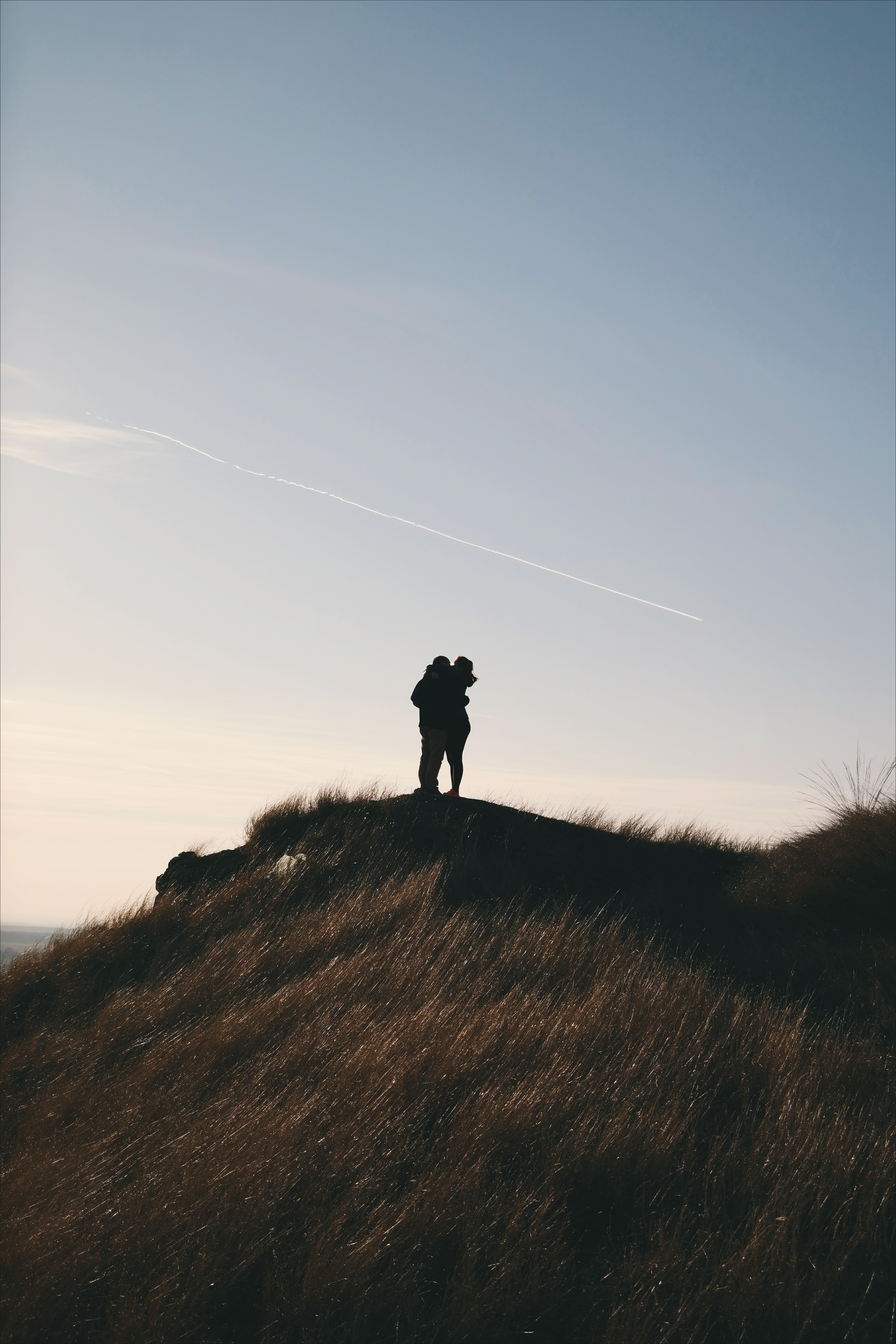 Couple standing on a mountain top, hiking, retired early