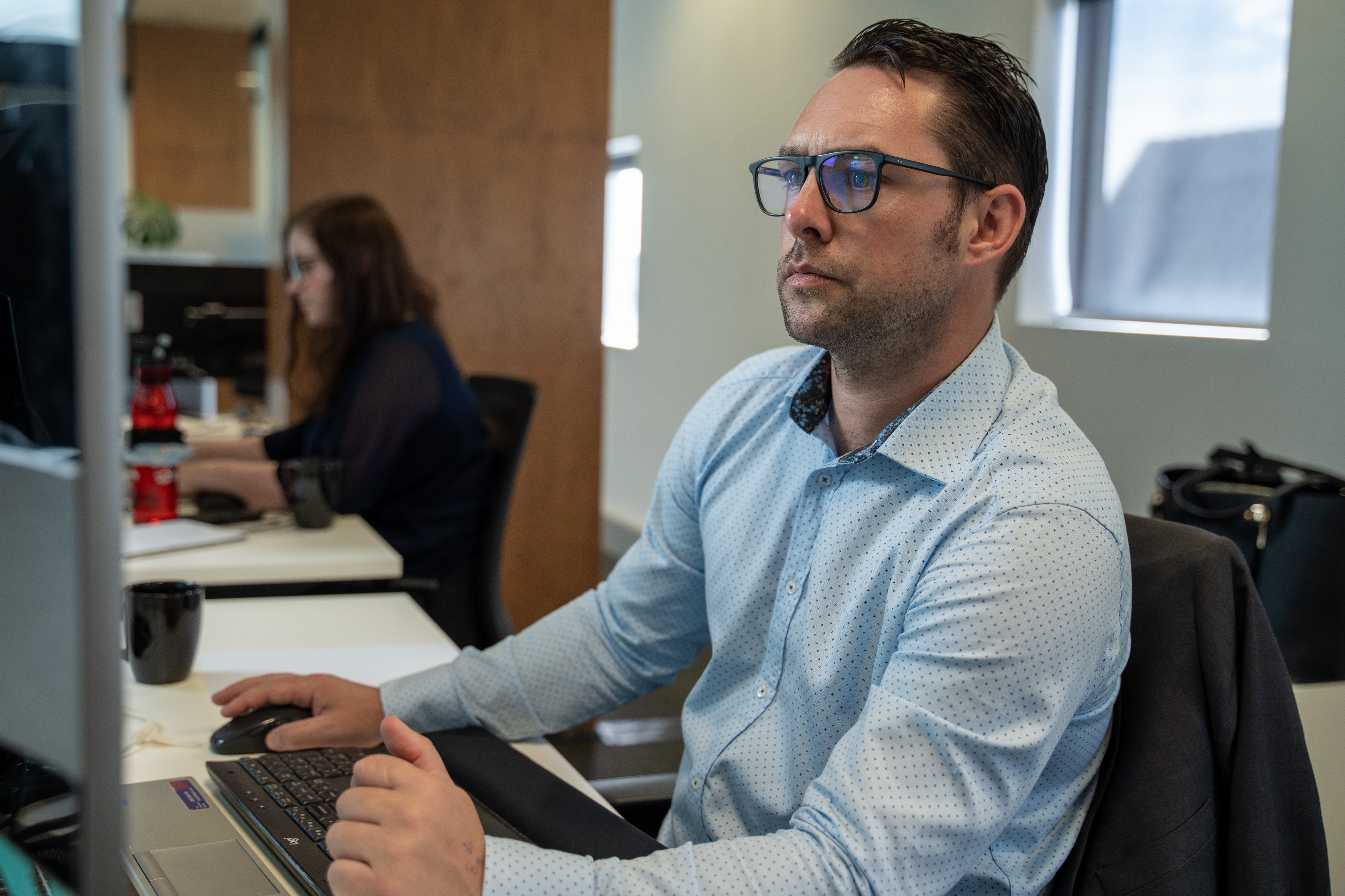 Marcus, financial adviser at Become Wealth, sitting in the office working on-screen