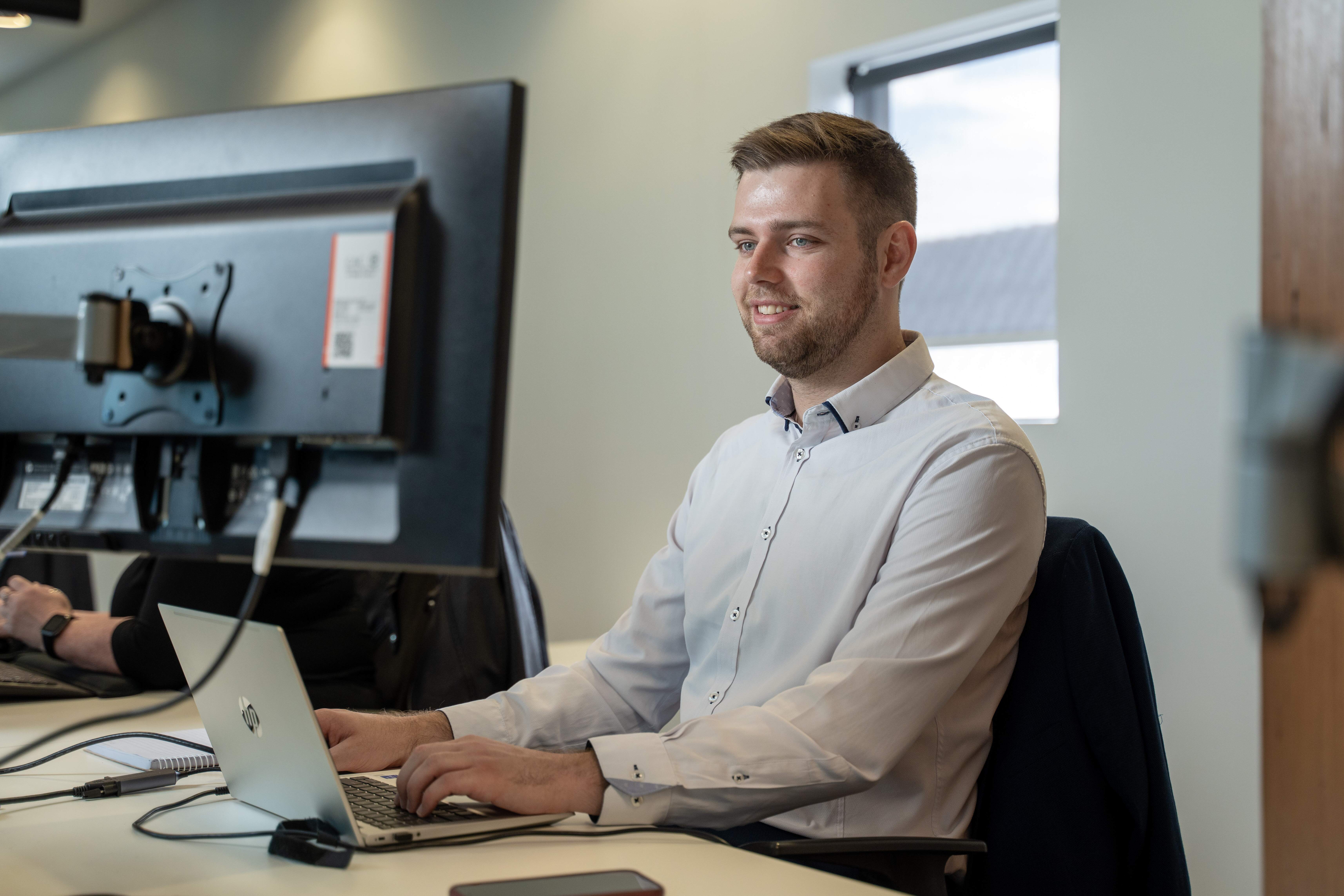 Josh Copeland, one of Become Wealth's financial advisers, working on his computer