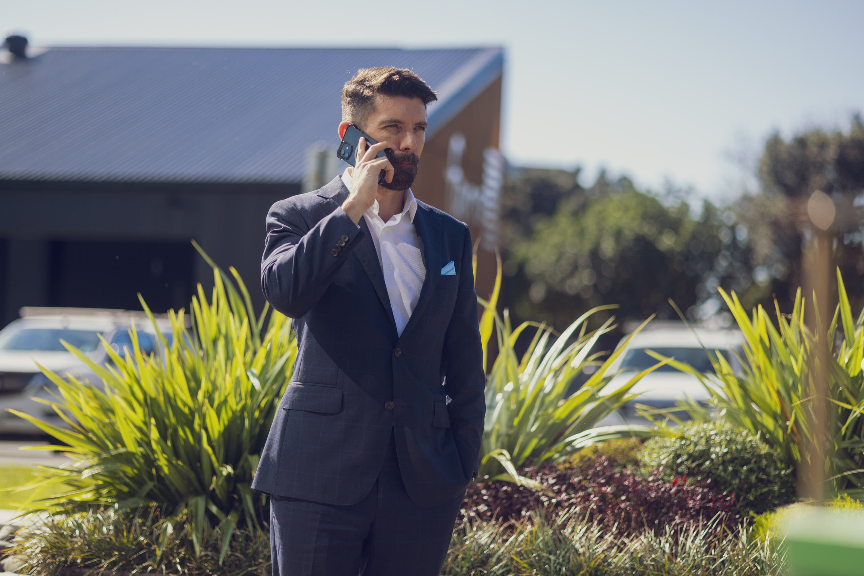 The Become Wealth CEO, Joseph Darby, standing outside, talking on his cellphone
