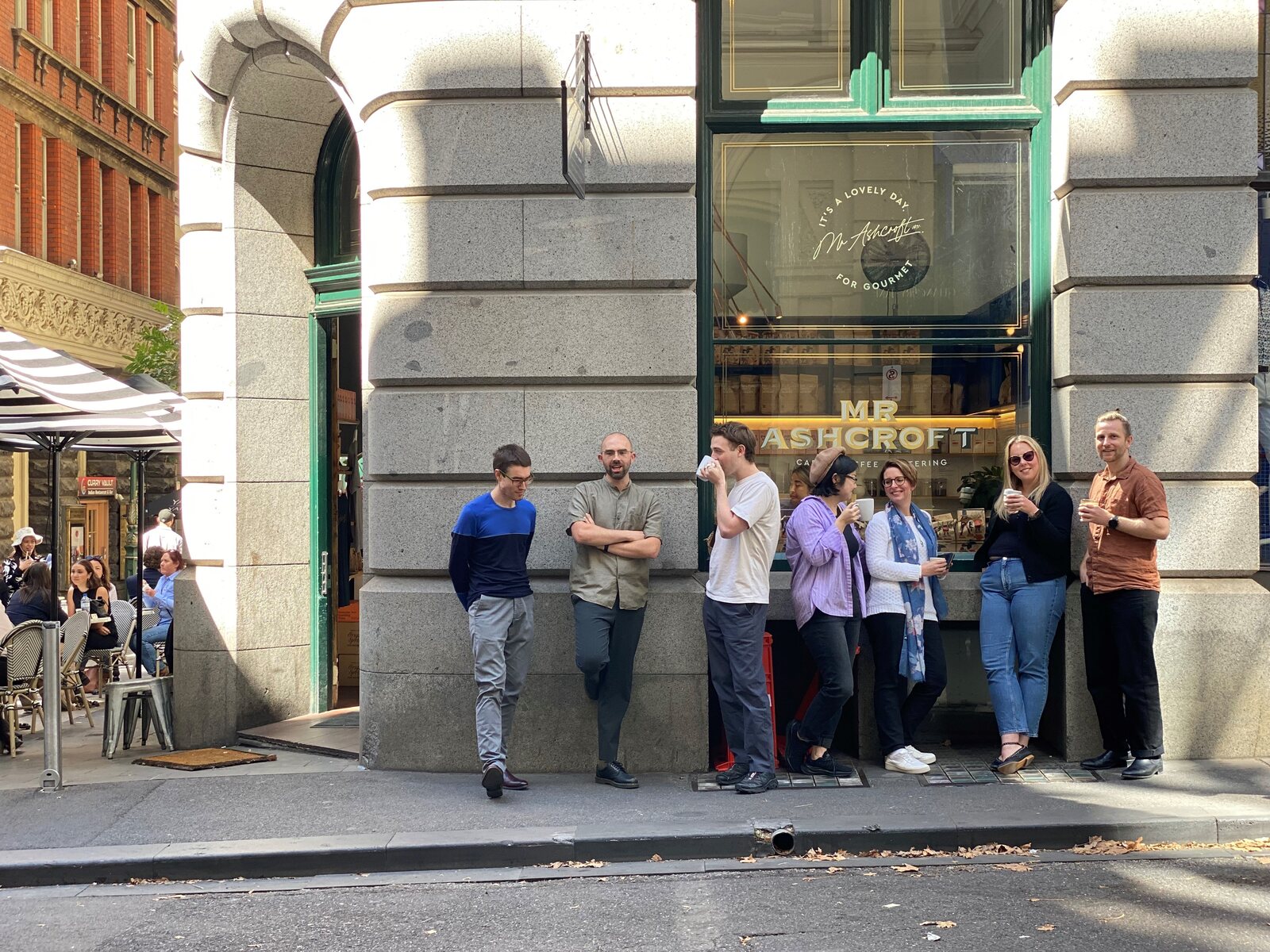 Cogency and UrbanFold teams together outside a Melbourne cafe