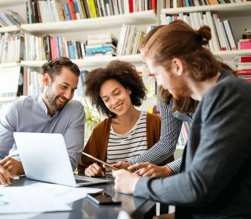 A group of four people collaborating in a workspace