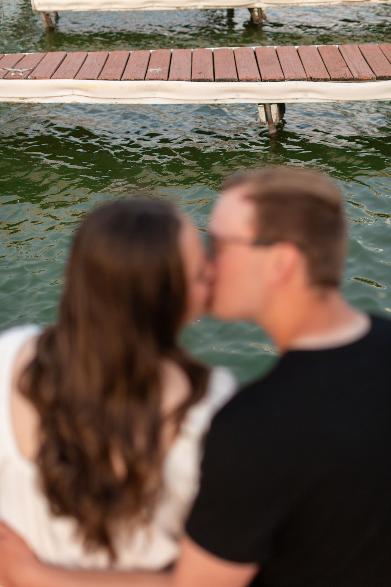 couple kissing by the lake