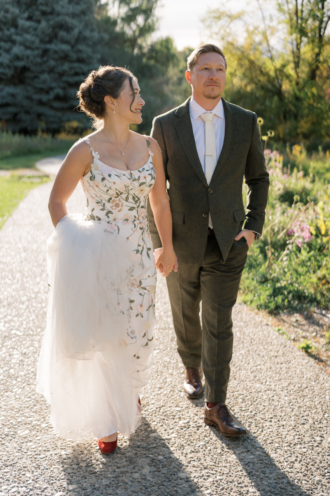 bride and groom holding hands and walking