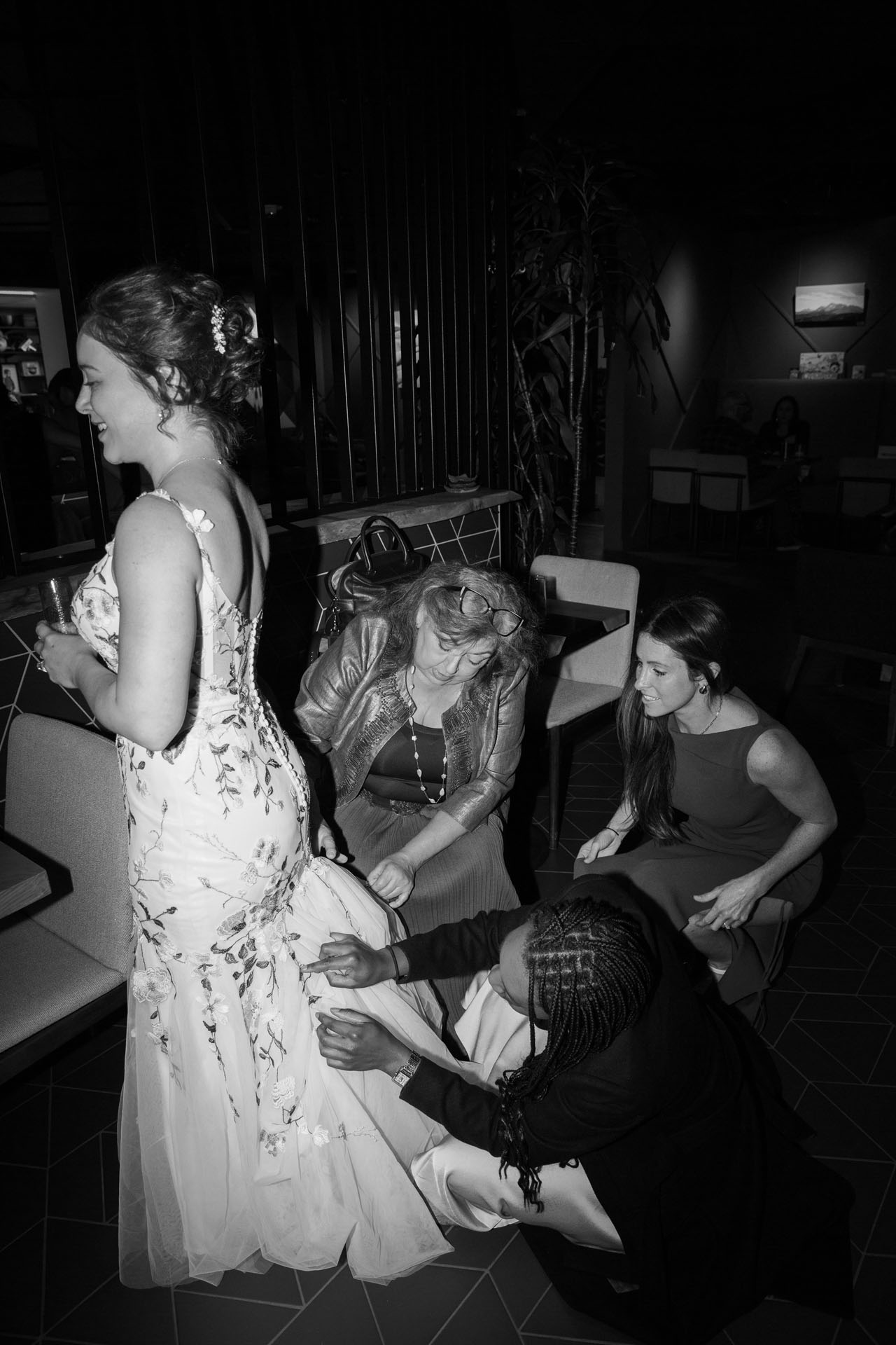 bride getting dress bustled