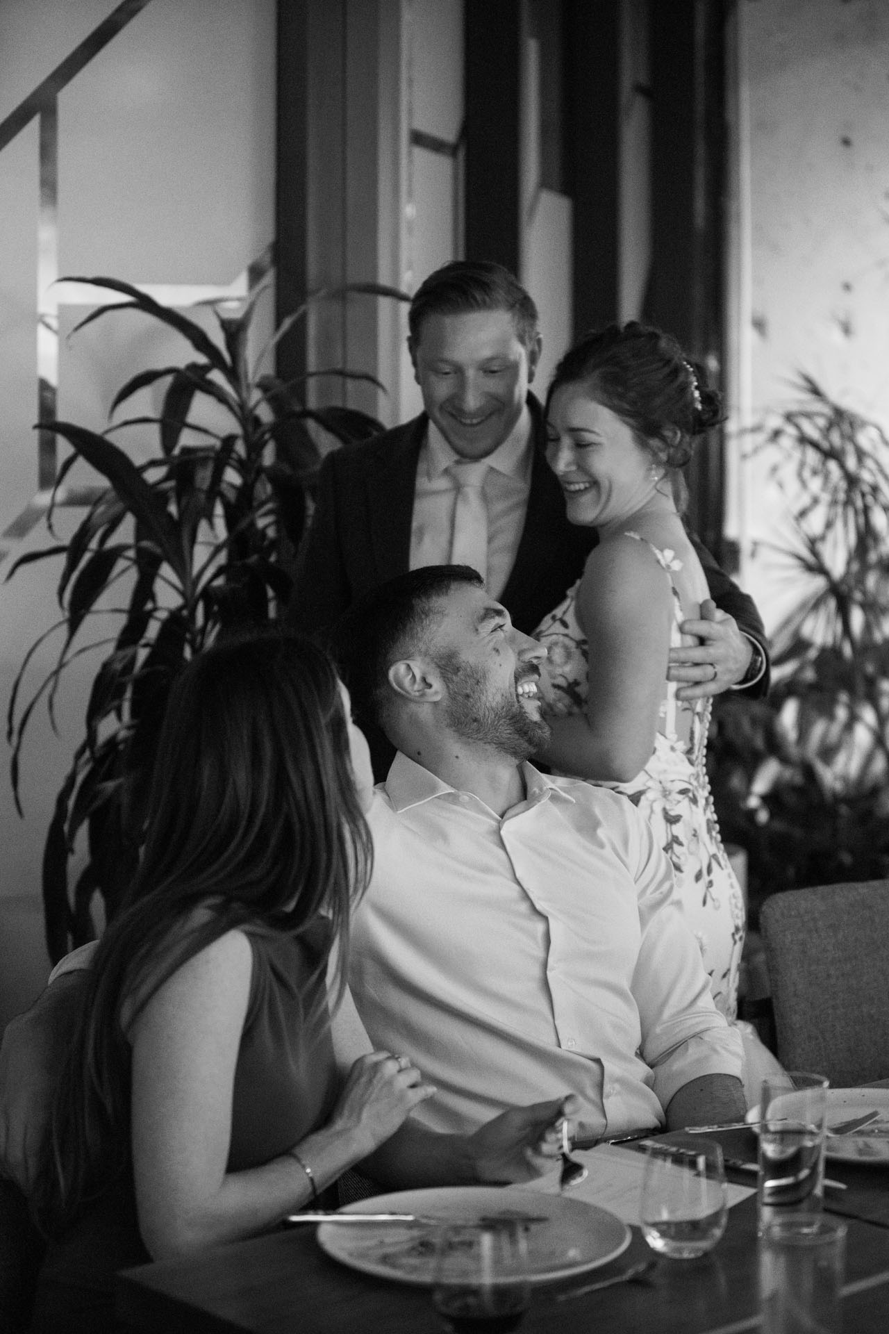 bride and groom laughing with friends