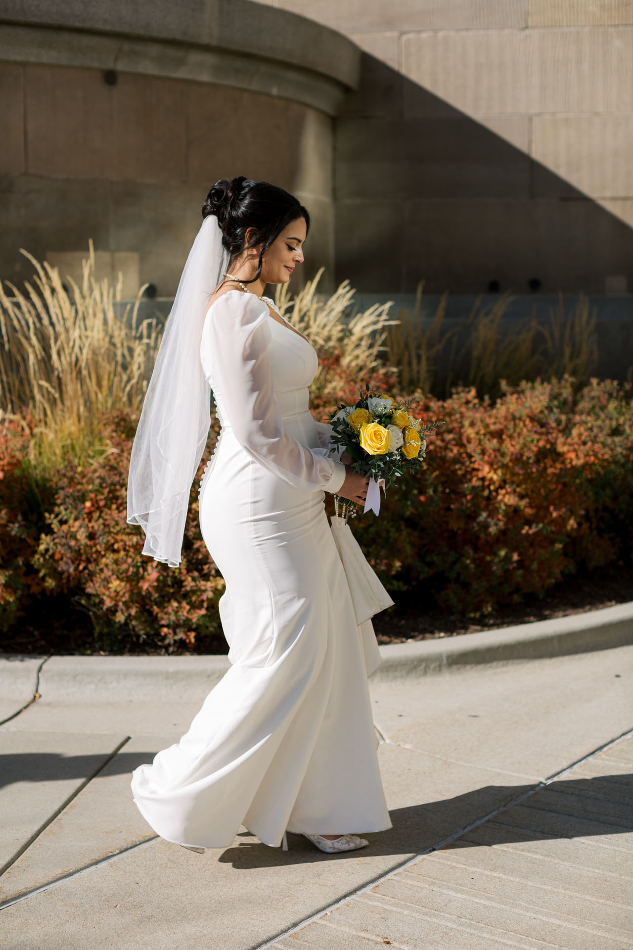 bride looking down at bouquet