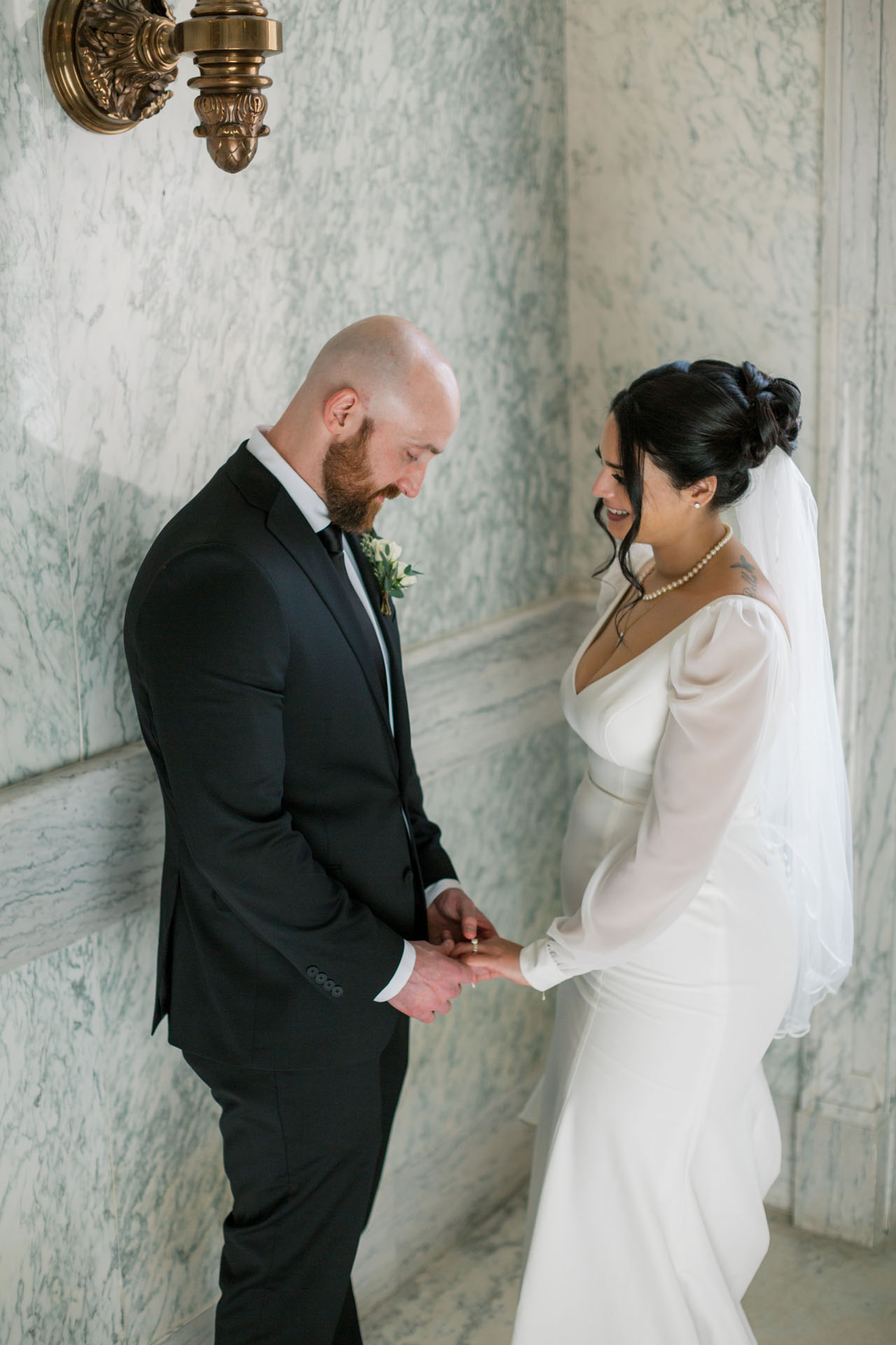 groom looking at bride's ring