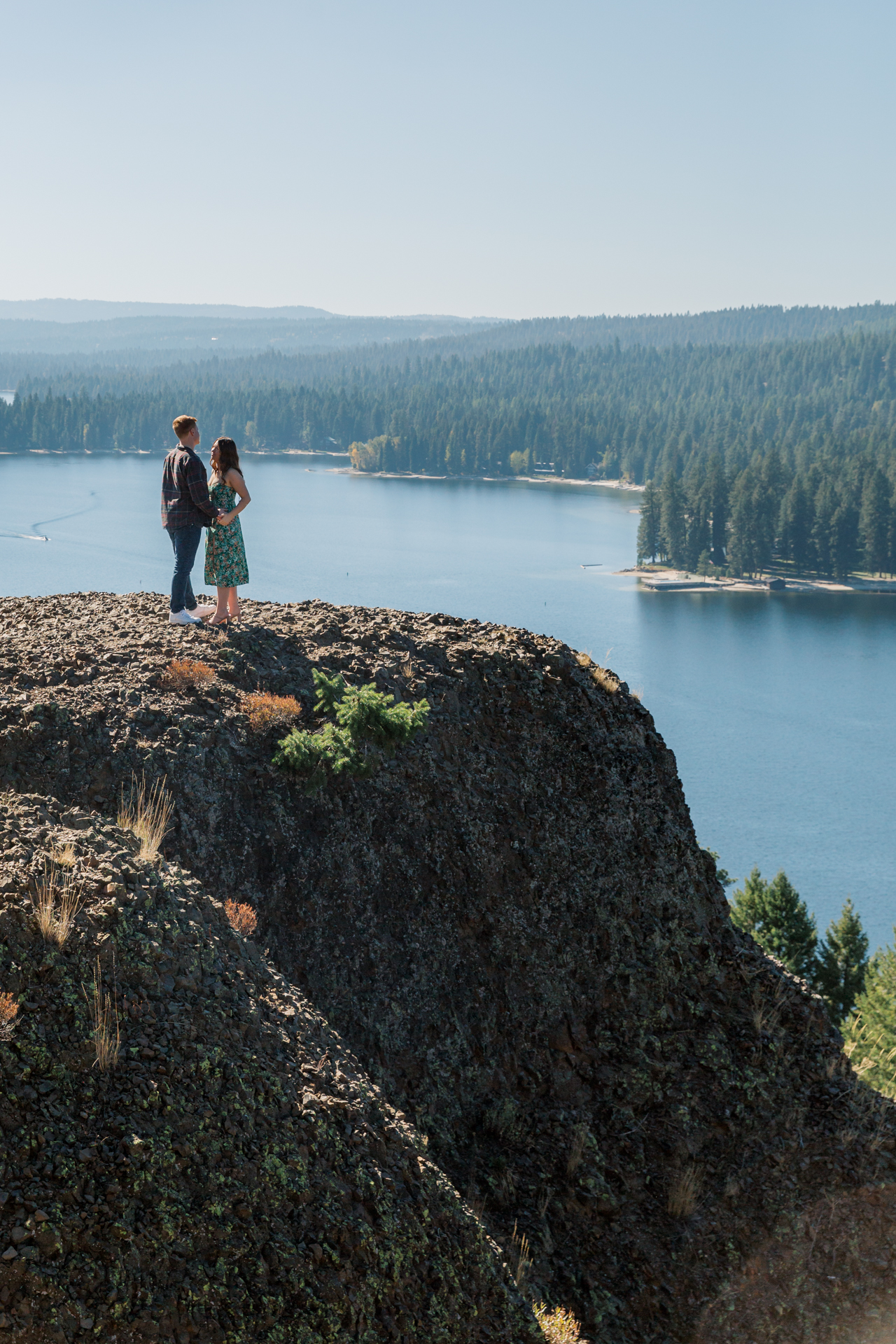 couple holding hands with Payette Lake in the background