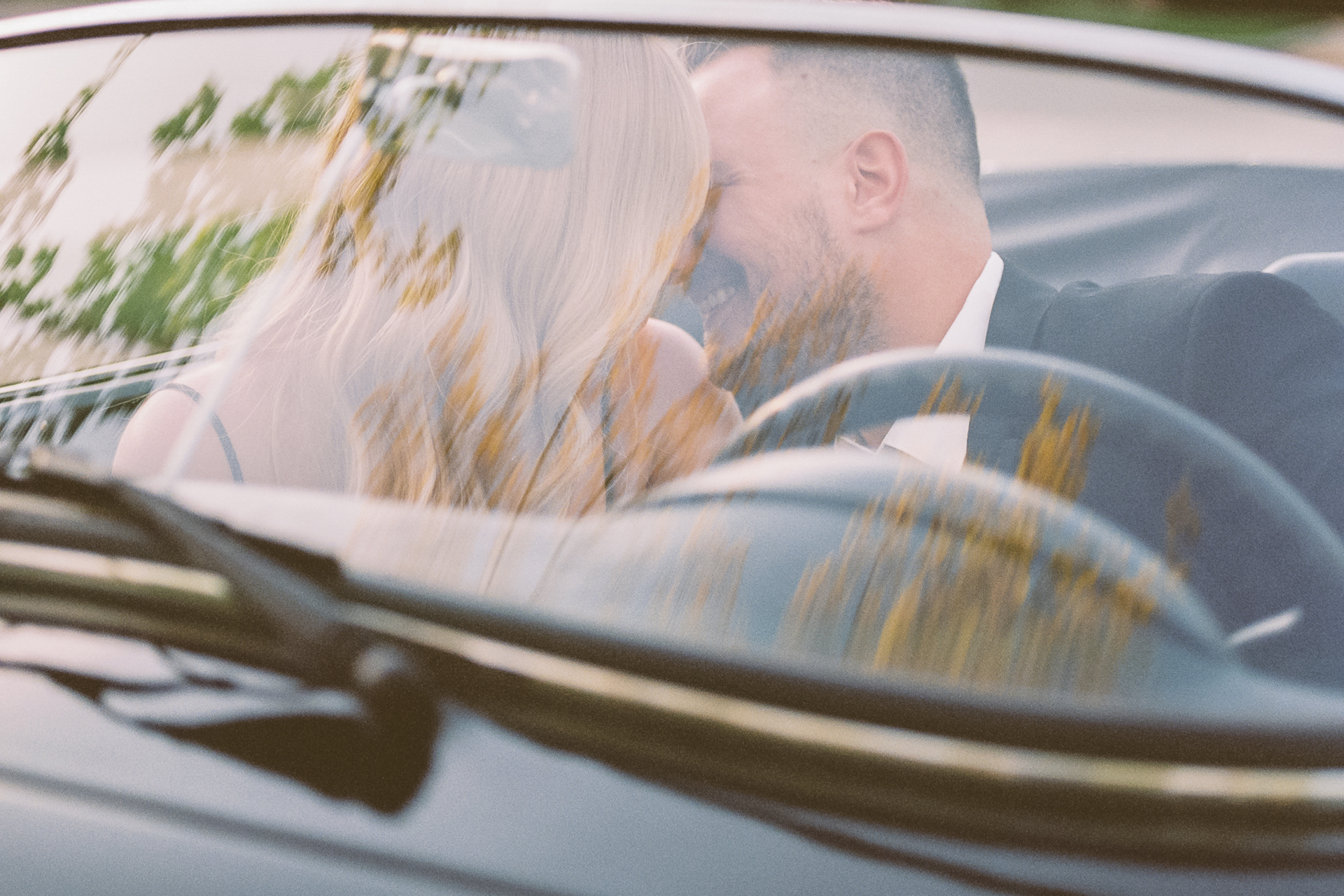 film photograph of couple in car