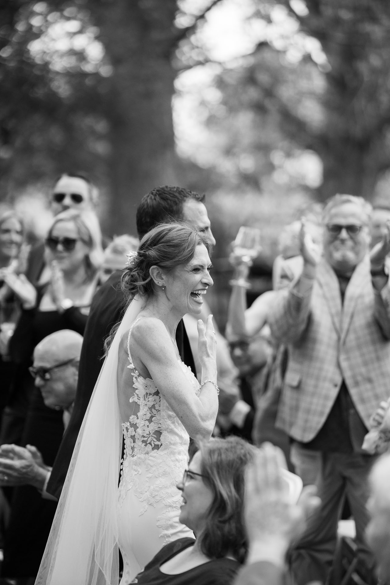 black and white wedding photograph of couple walking down the aisle