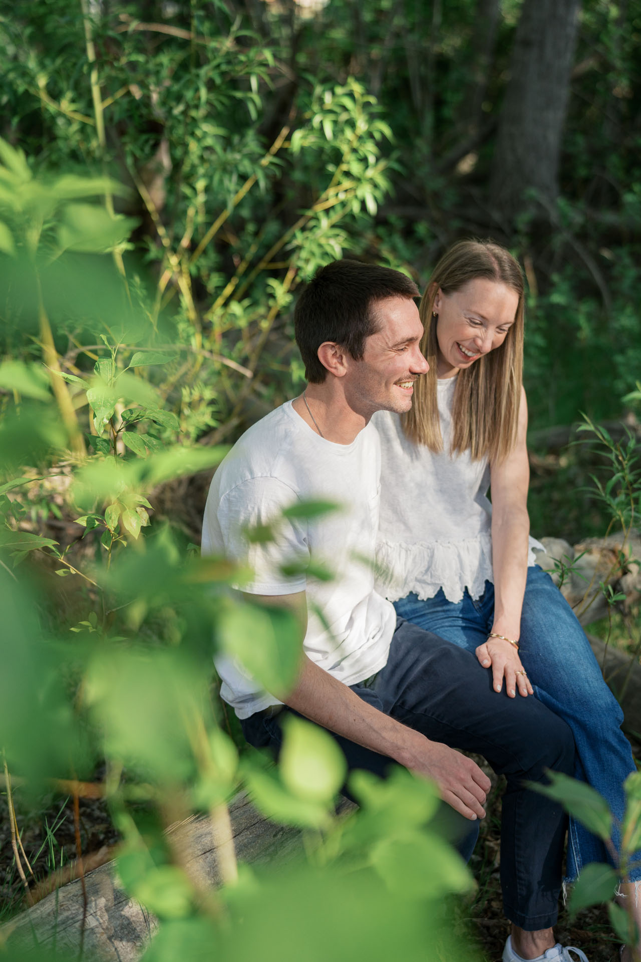 couple sitting on a log near the Boise river