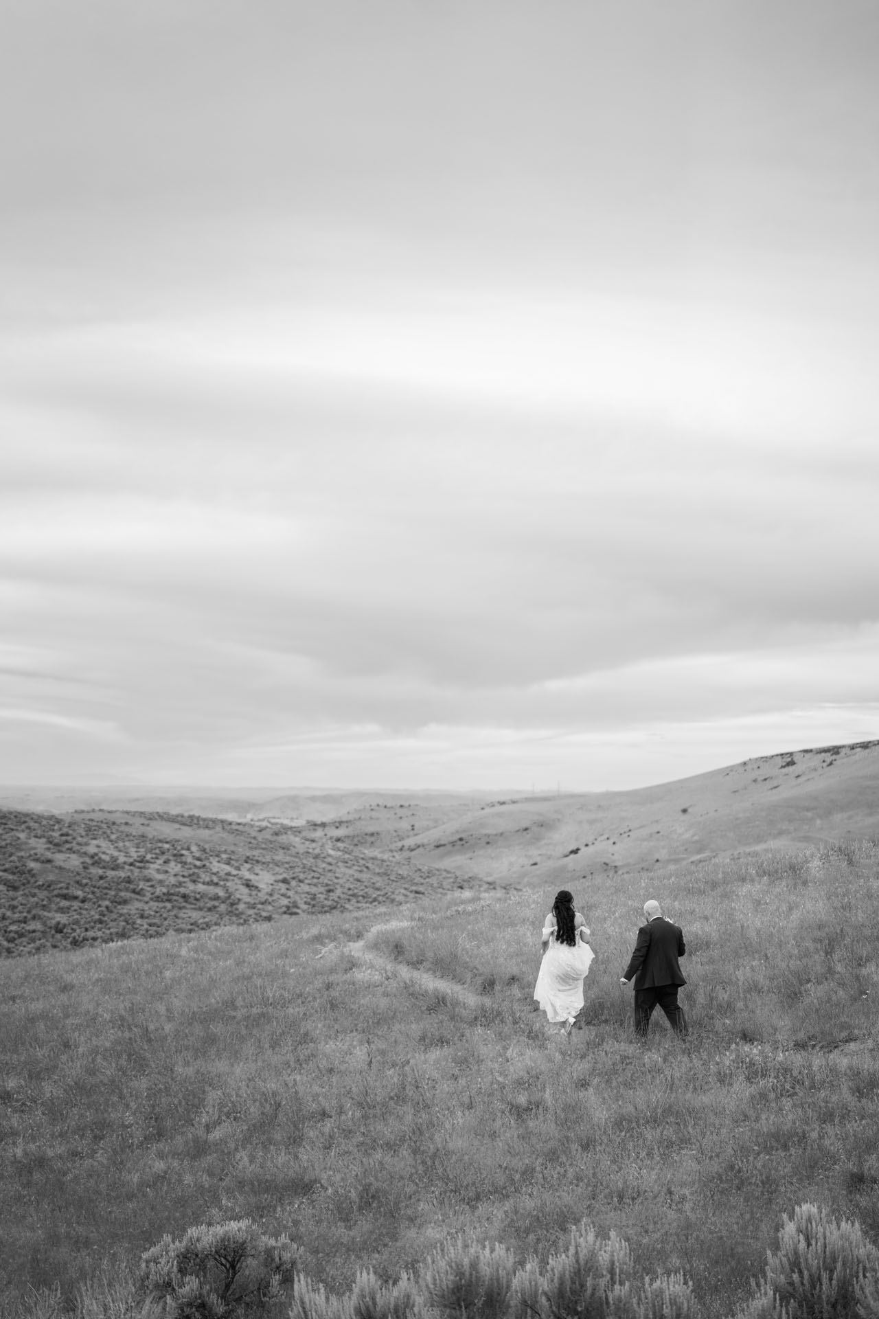 couple walking to elopement spot in the boise foothills