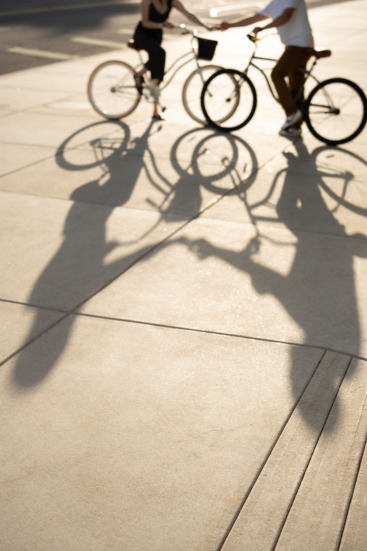 bike shadows of couple holding hands
