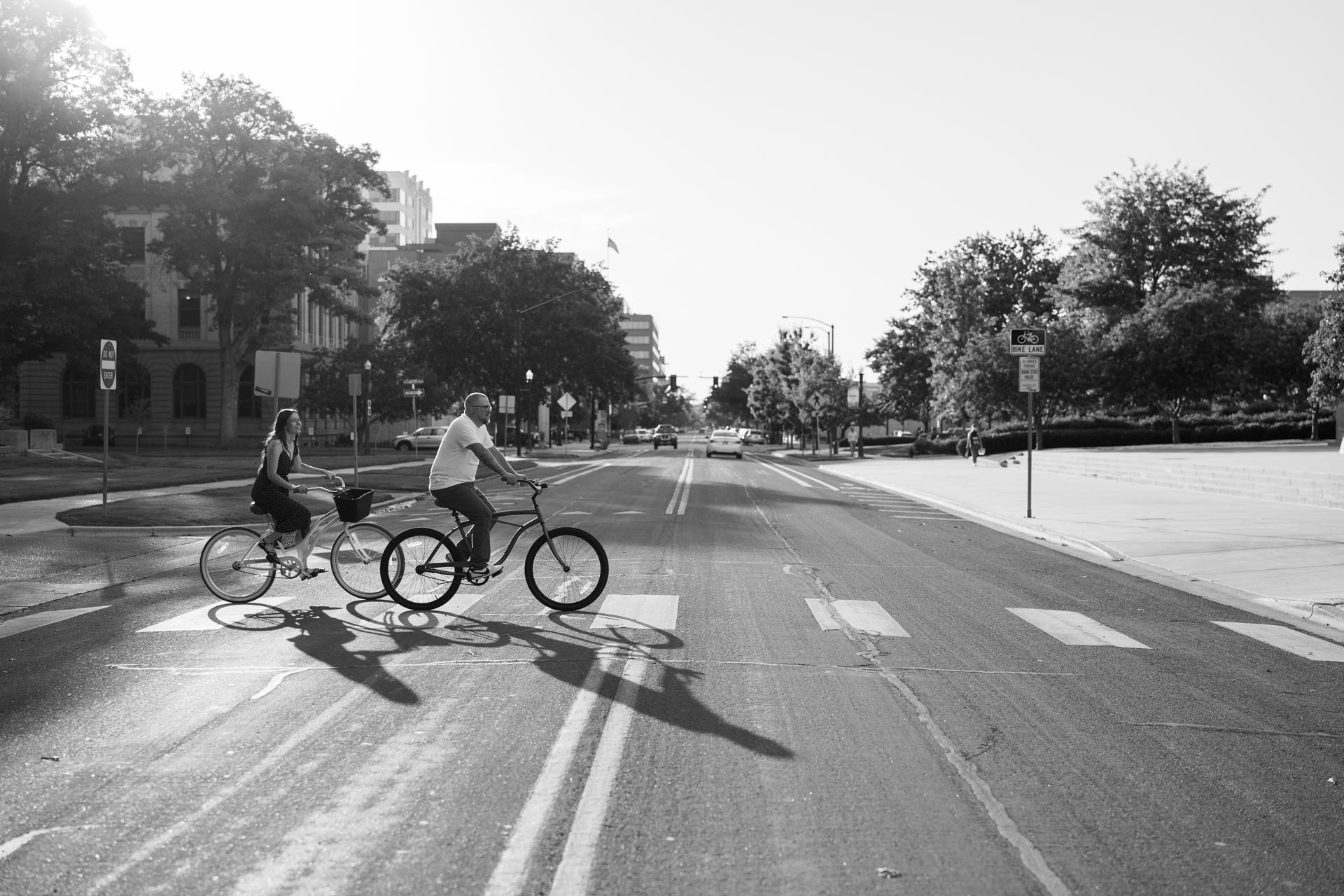 couple riding bikes across the street