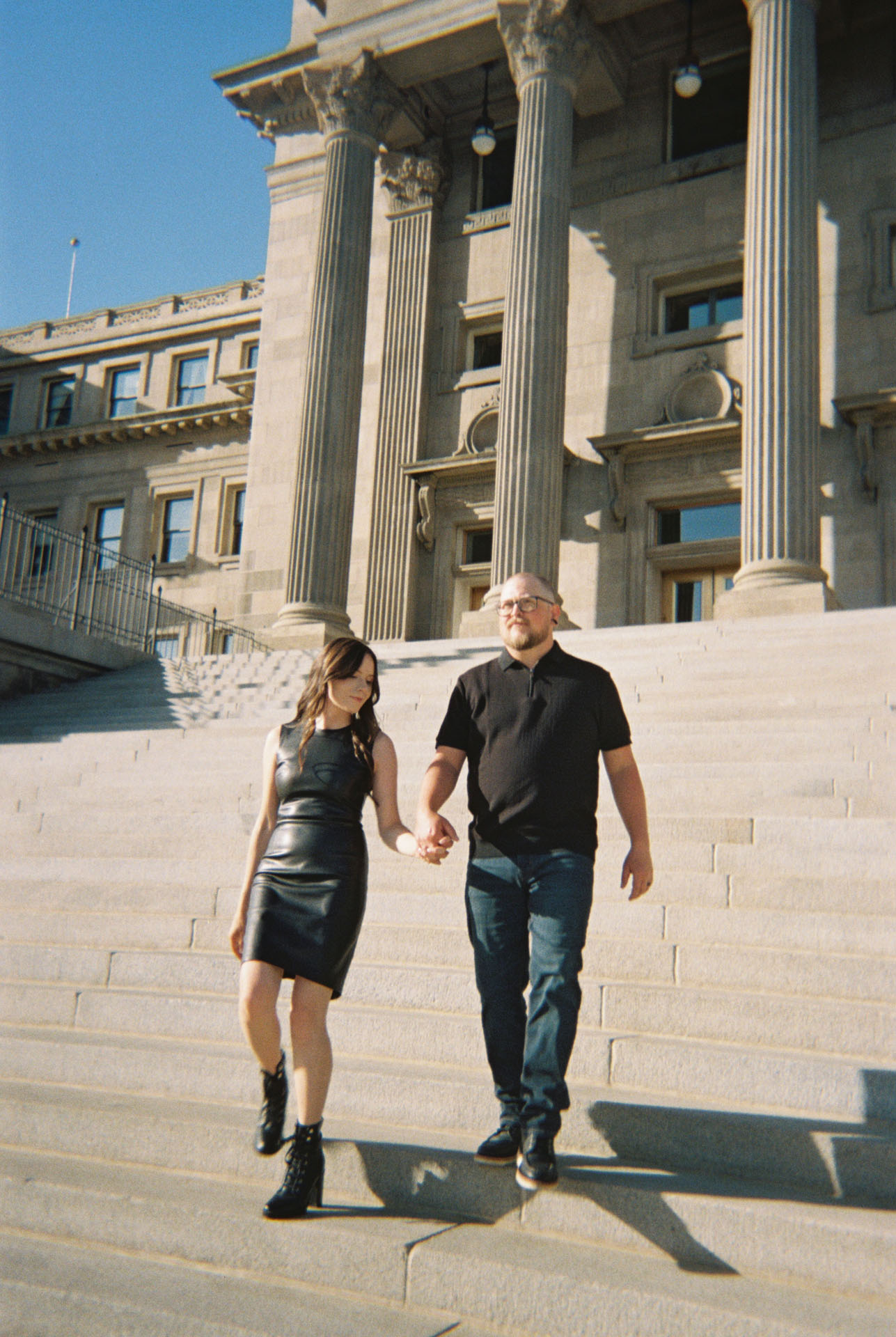 couple walking the steps of the Boise Capitol