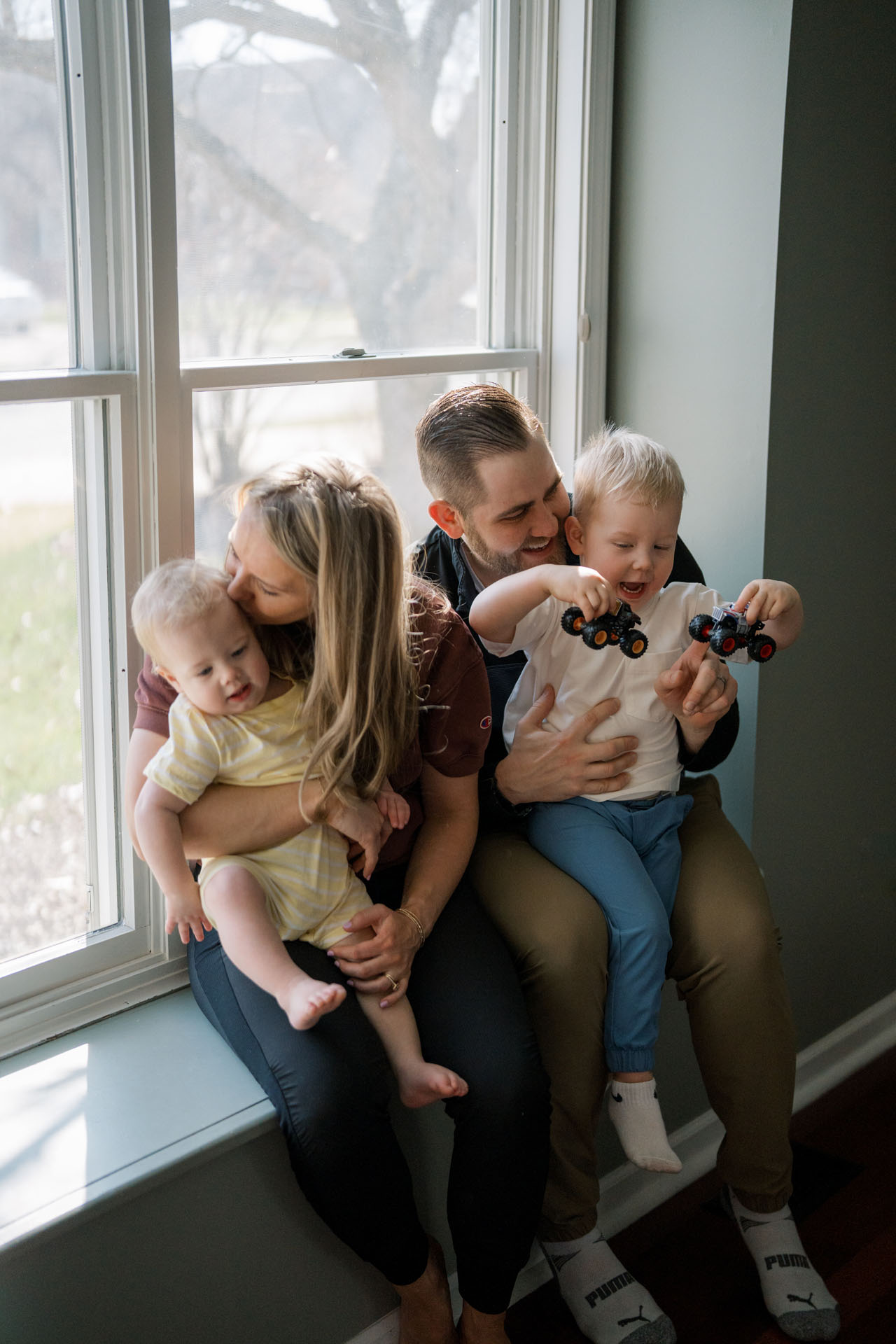 family sitting together in window