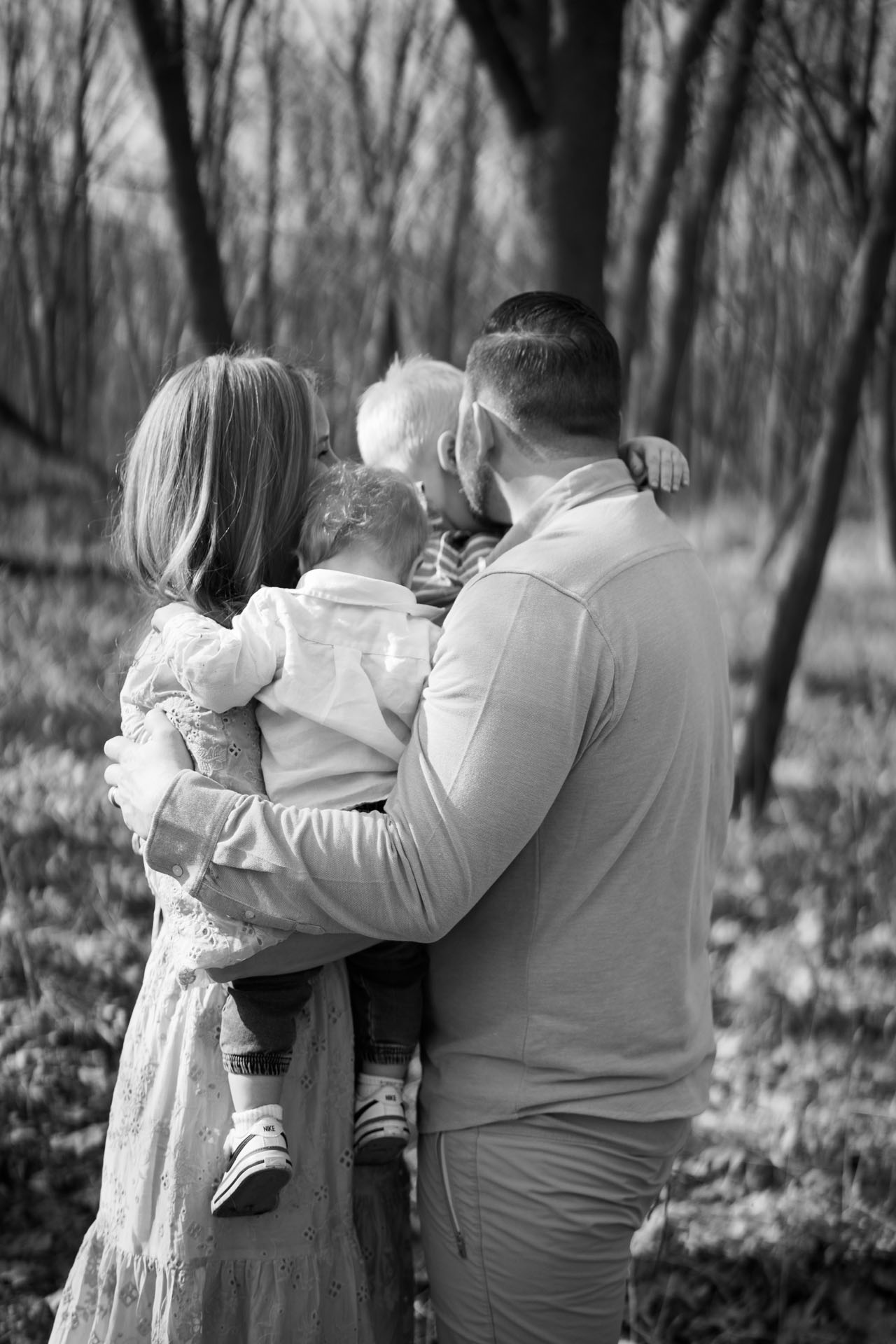 family hugging in their backyard