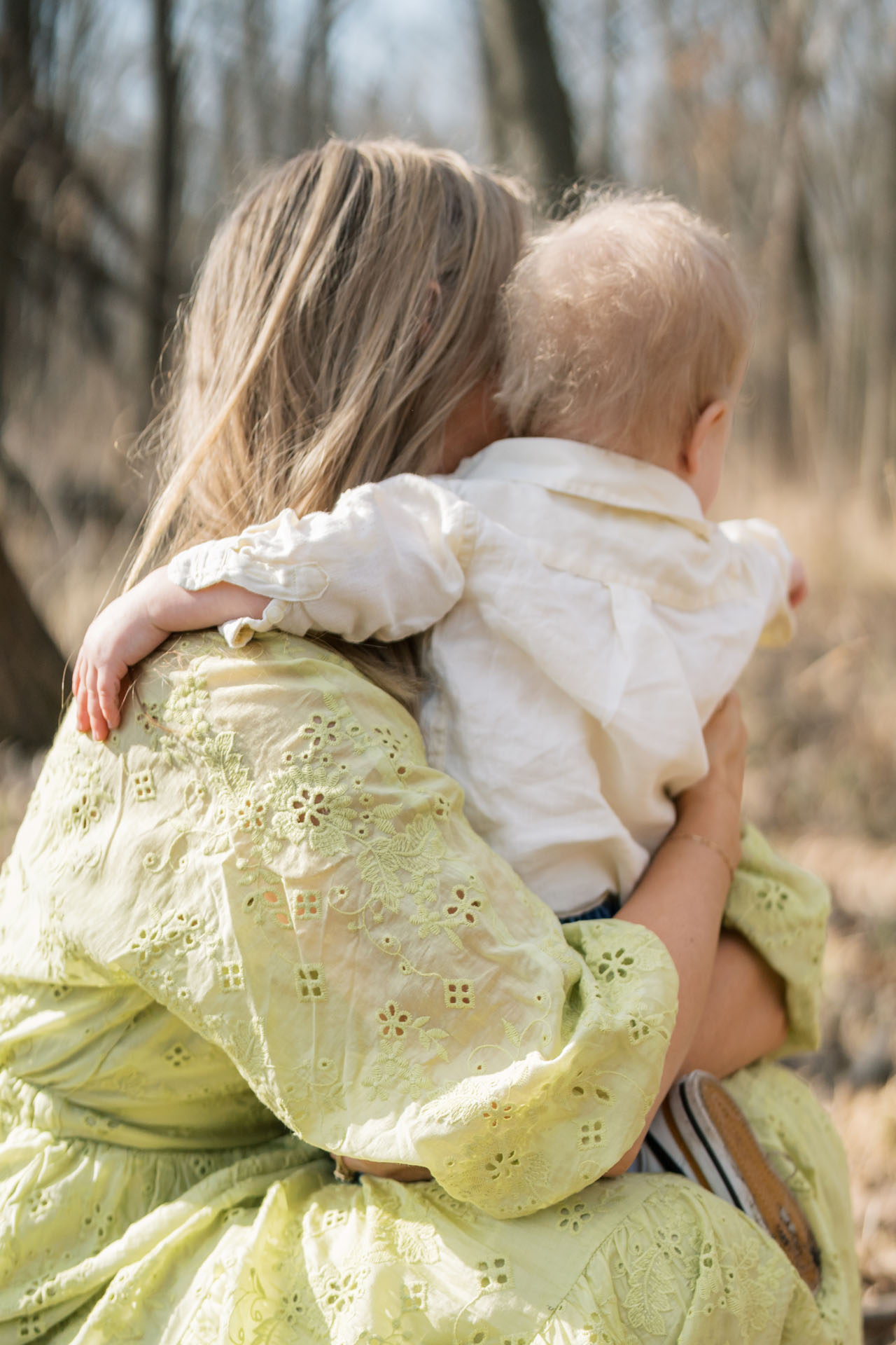 toddler's arm on mom's shoulder