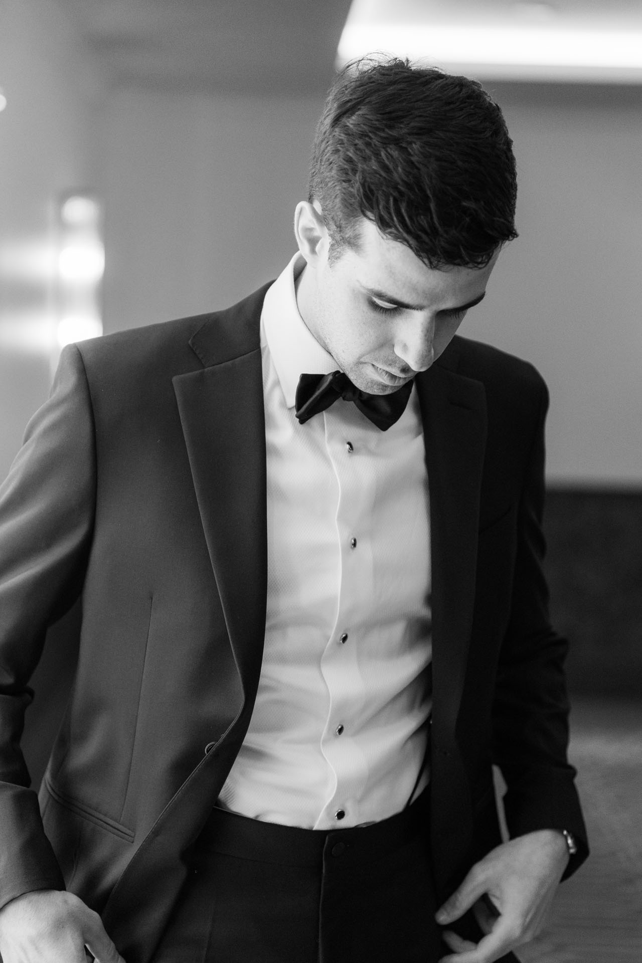 black and white groom portrait while getting ready