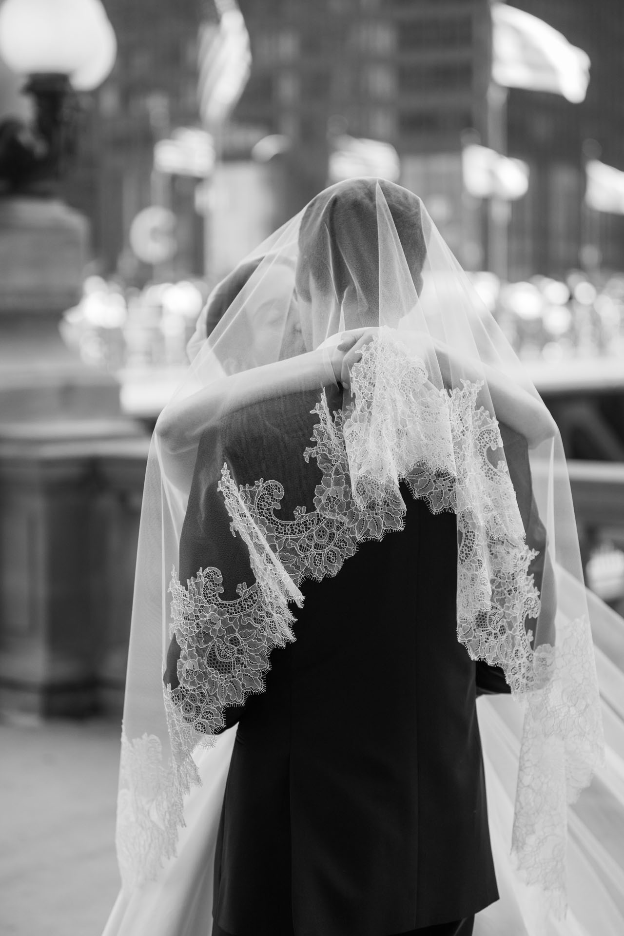bride and groom kissing under the bride's veil