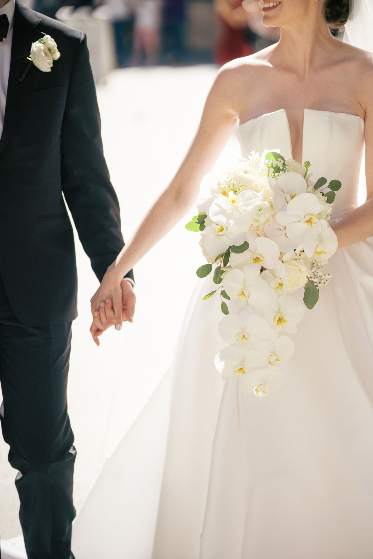 bride and groom holding hands