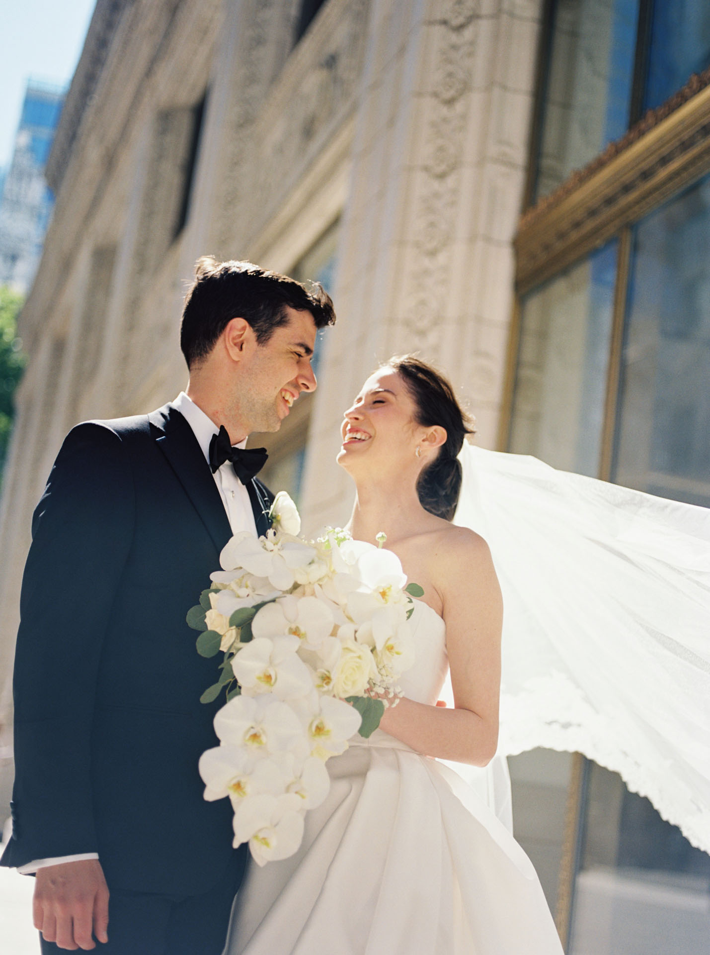 bride and groom laughing in the sunshine