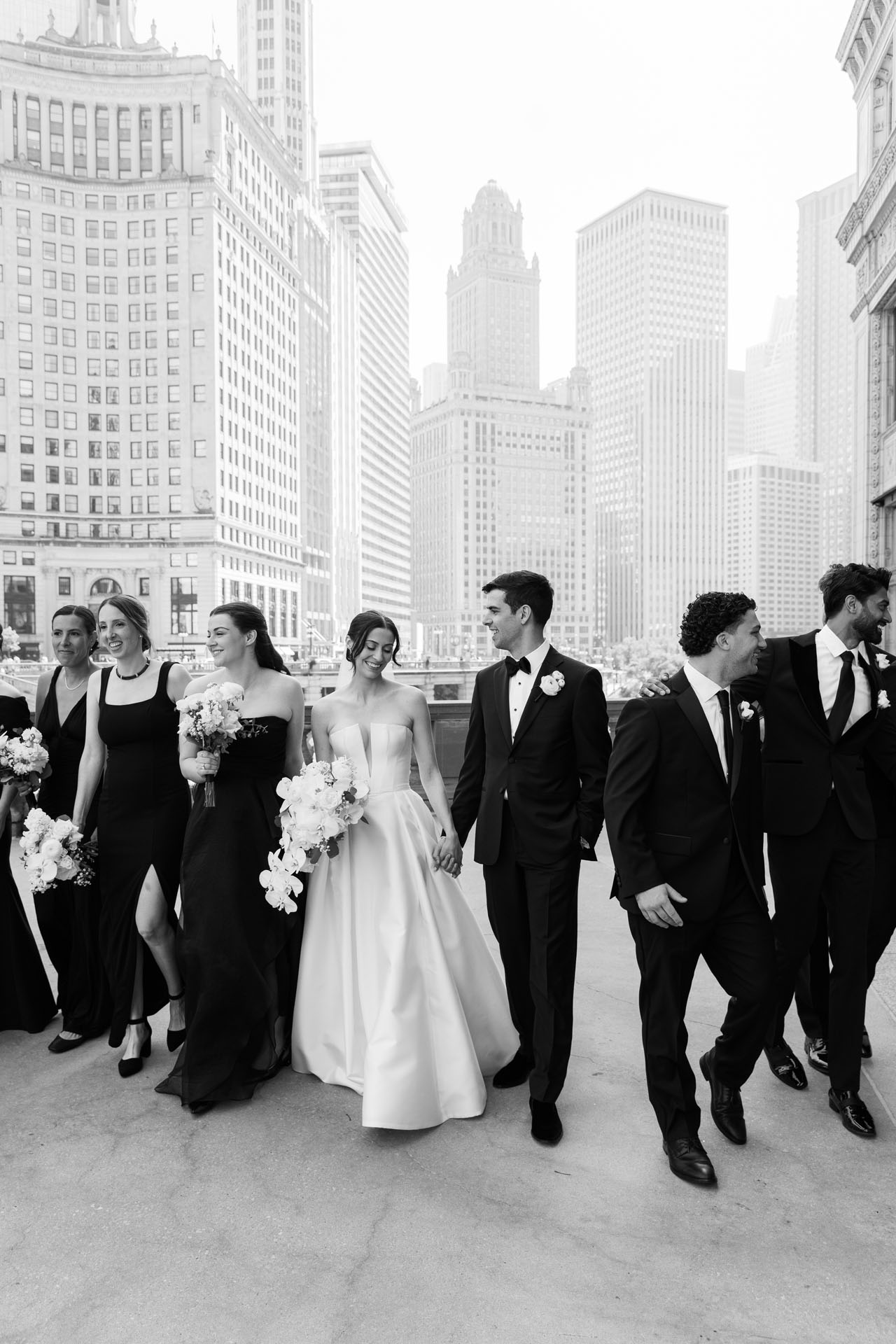 bride and groom walking with their wedding party