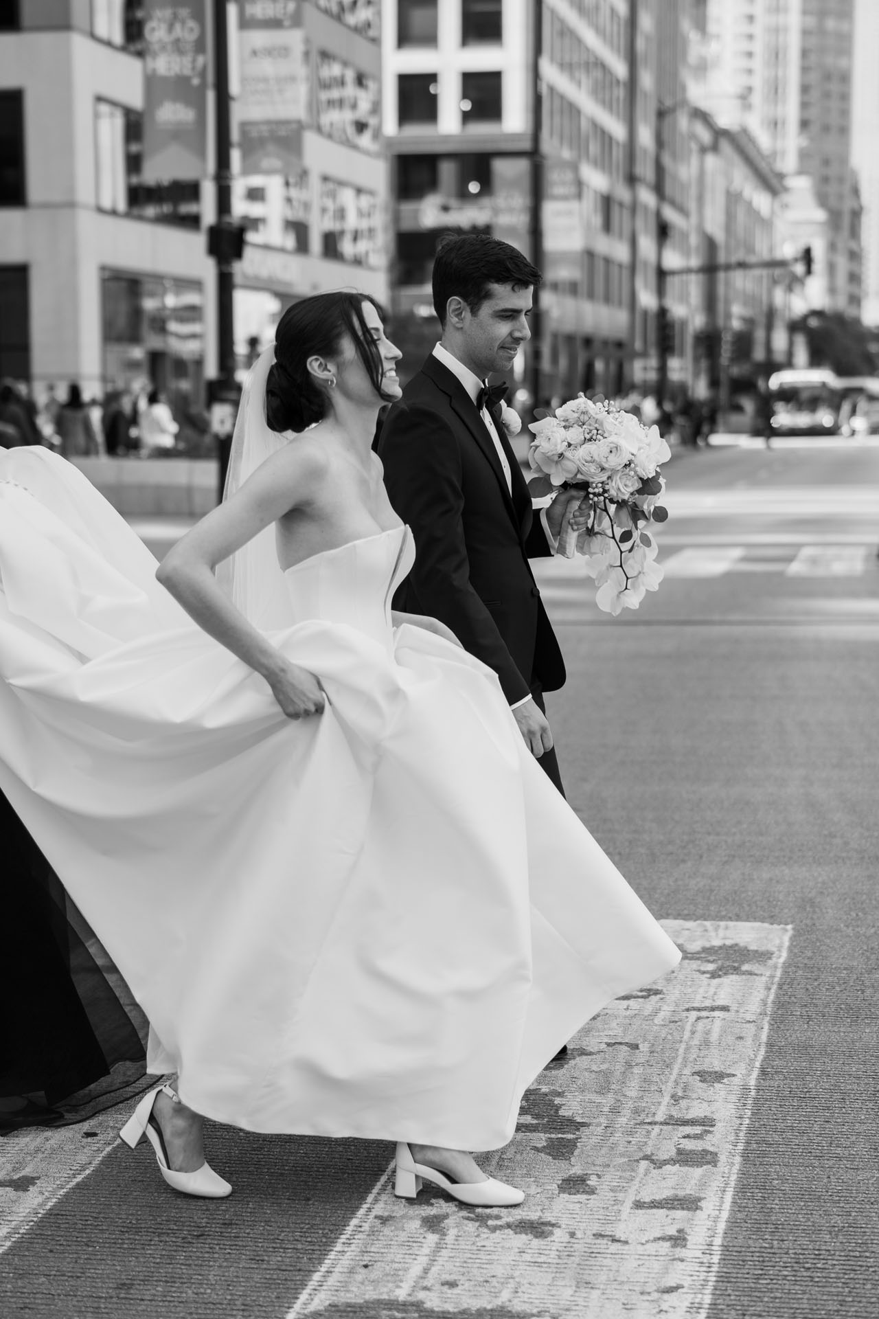 bride and groom walking the city streets in Chicago