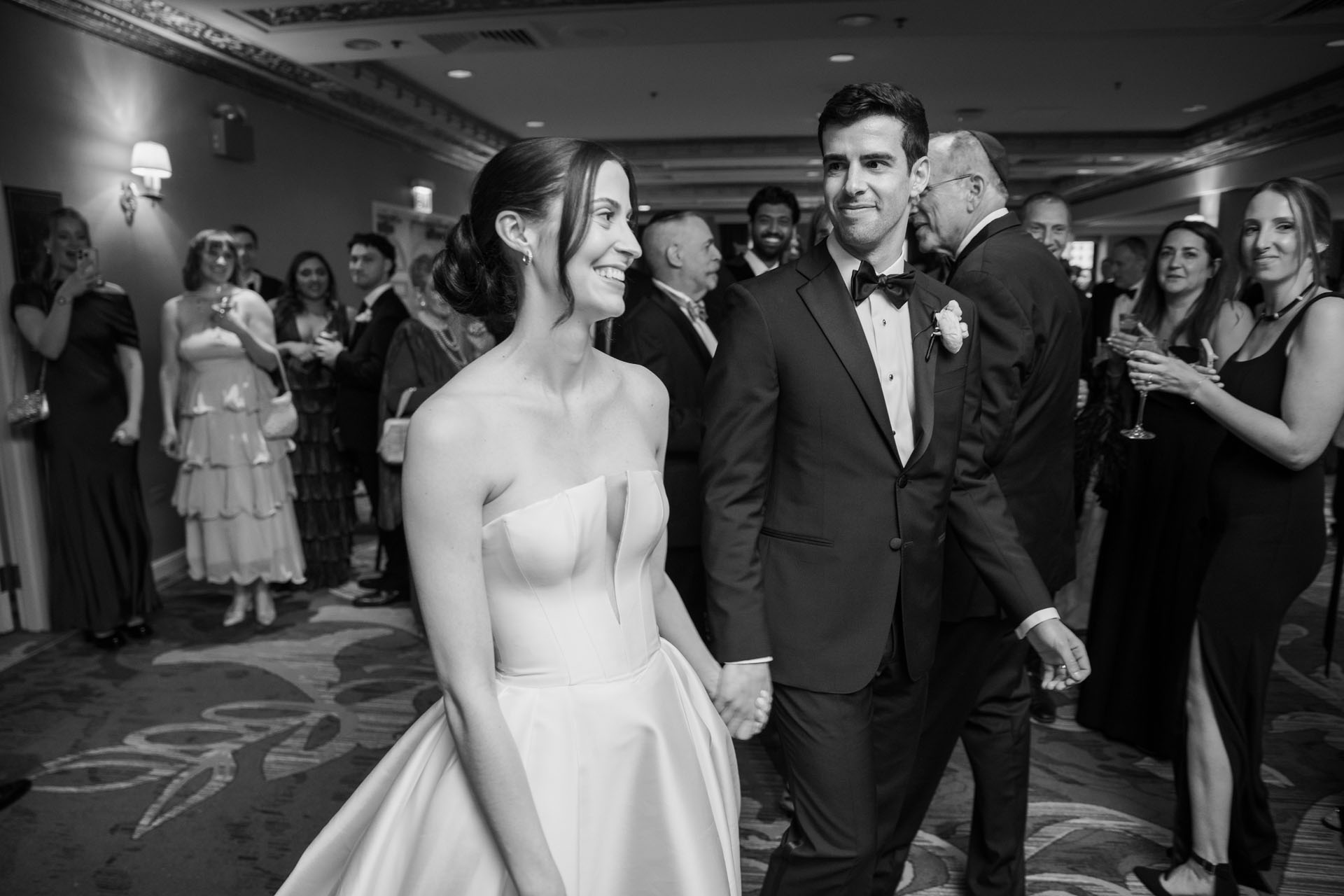 bride and groom walking into their cocktail hour