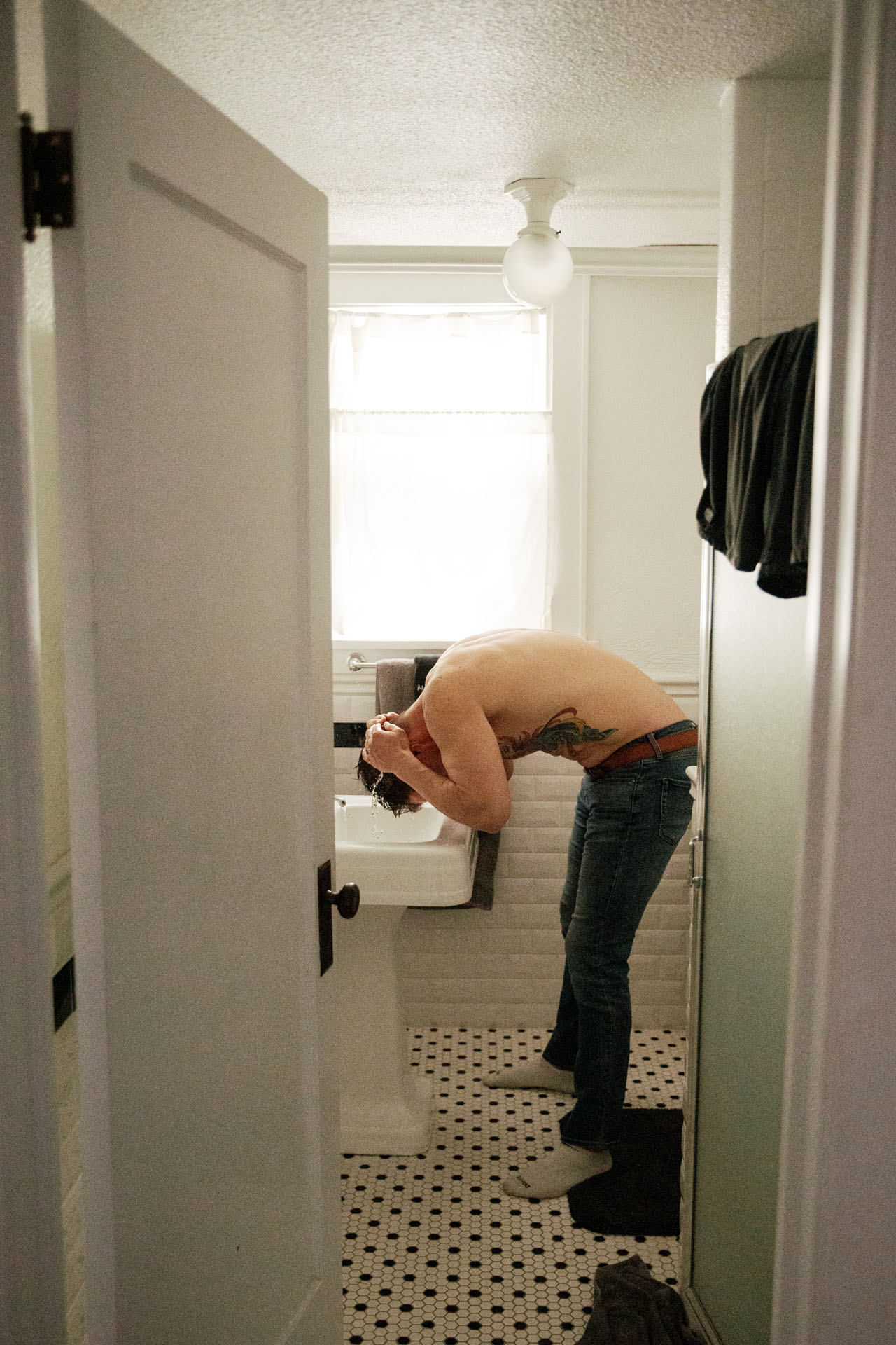 groom washing his hair in the sink