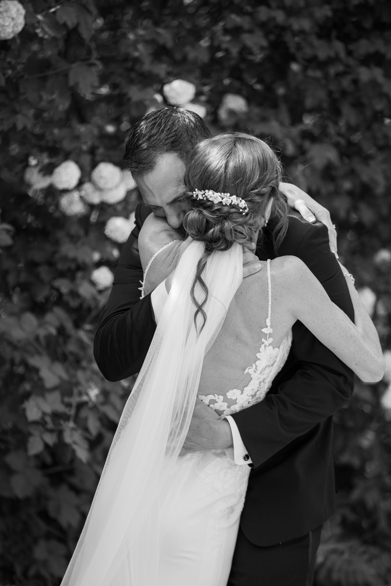 bride and groom hugging