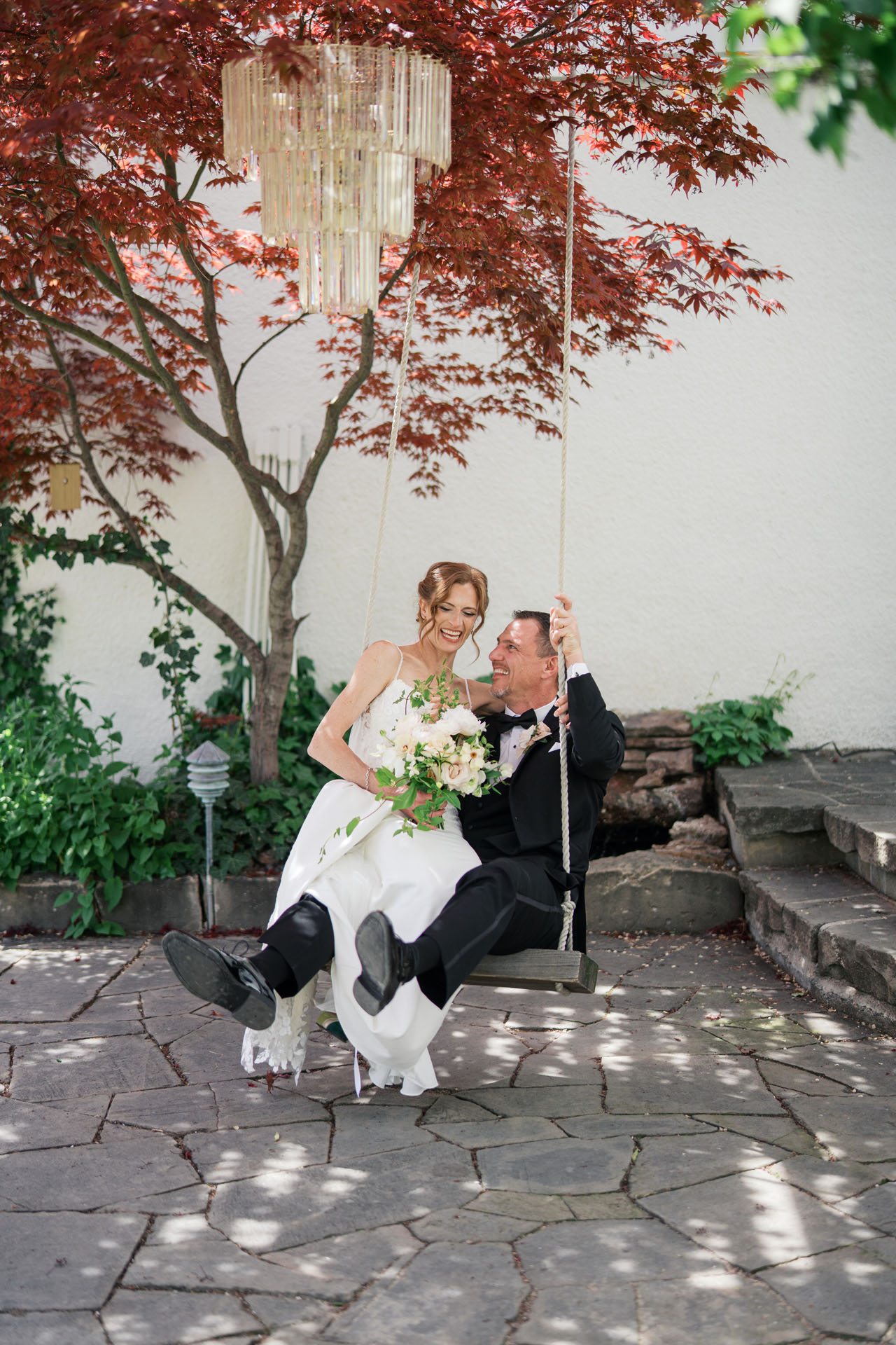 bride and groom on porch swing