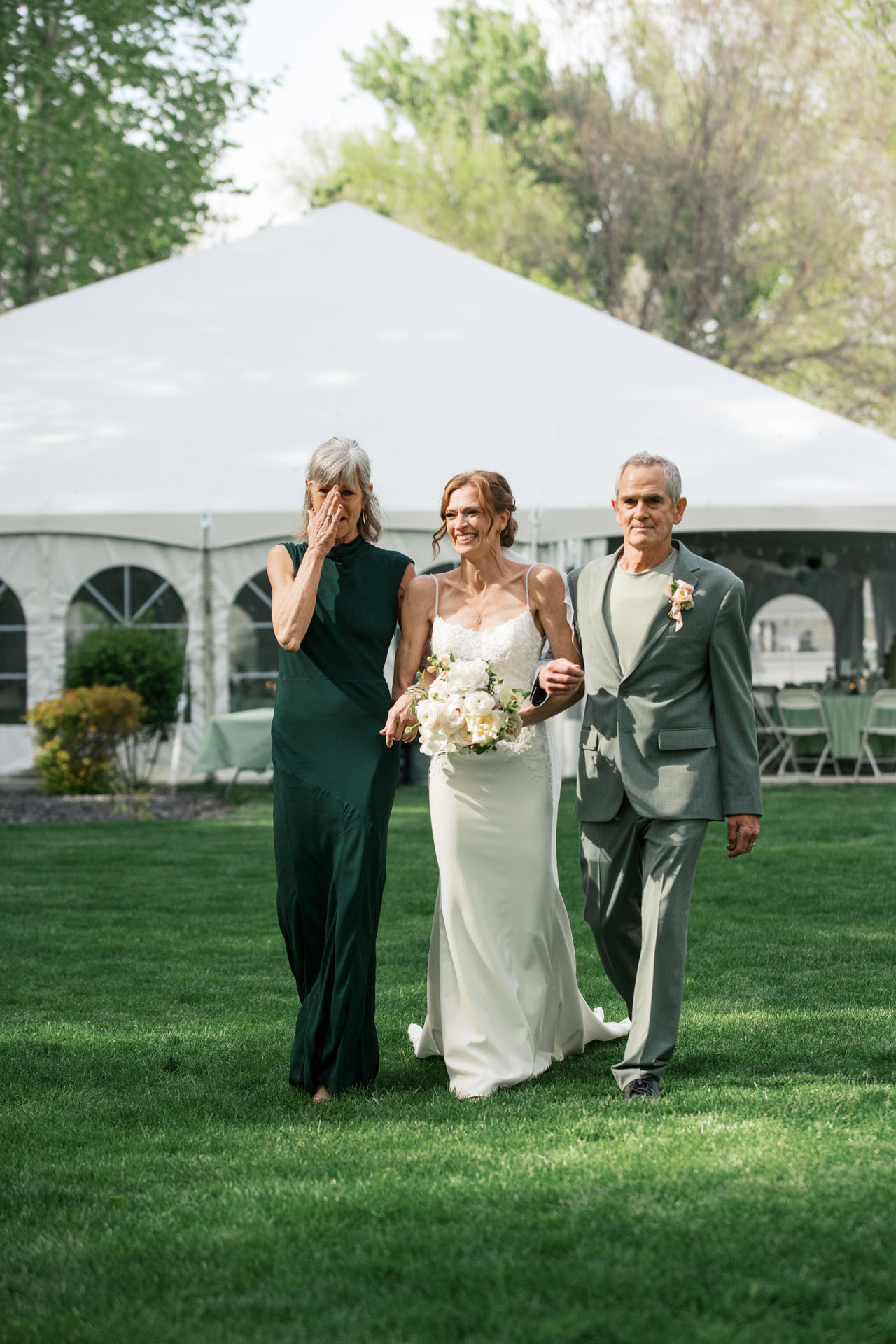 bride walking down the aisle with her parents