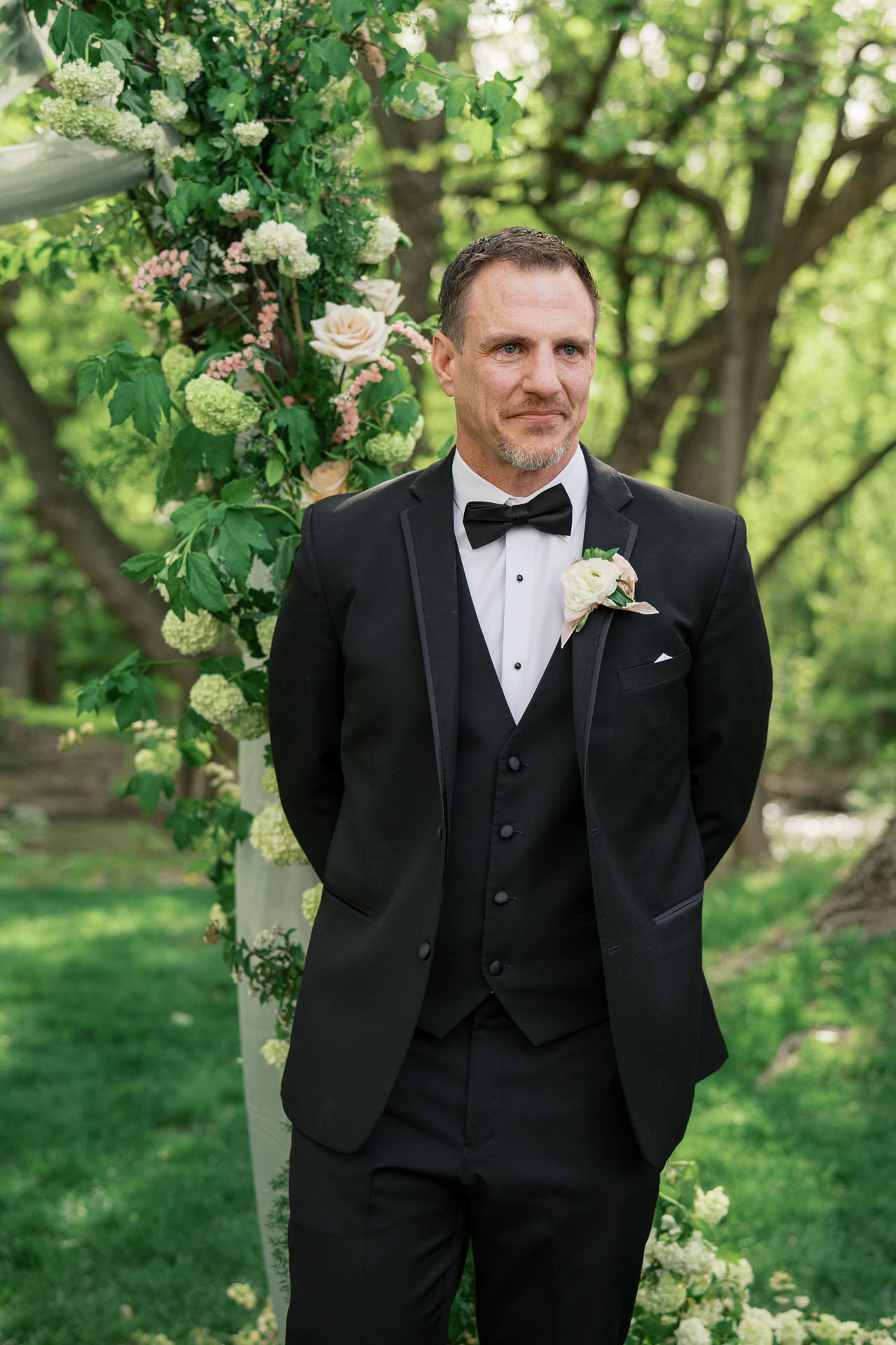 groom crying as bride walks down the aisle