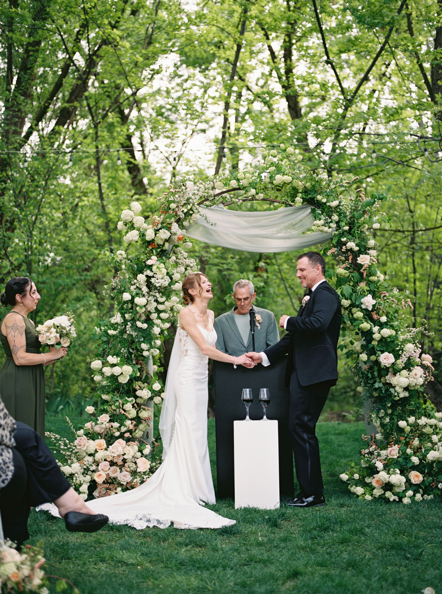 bride and groom laughing during outdoor wedding ceremony
